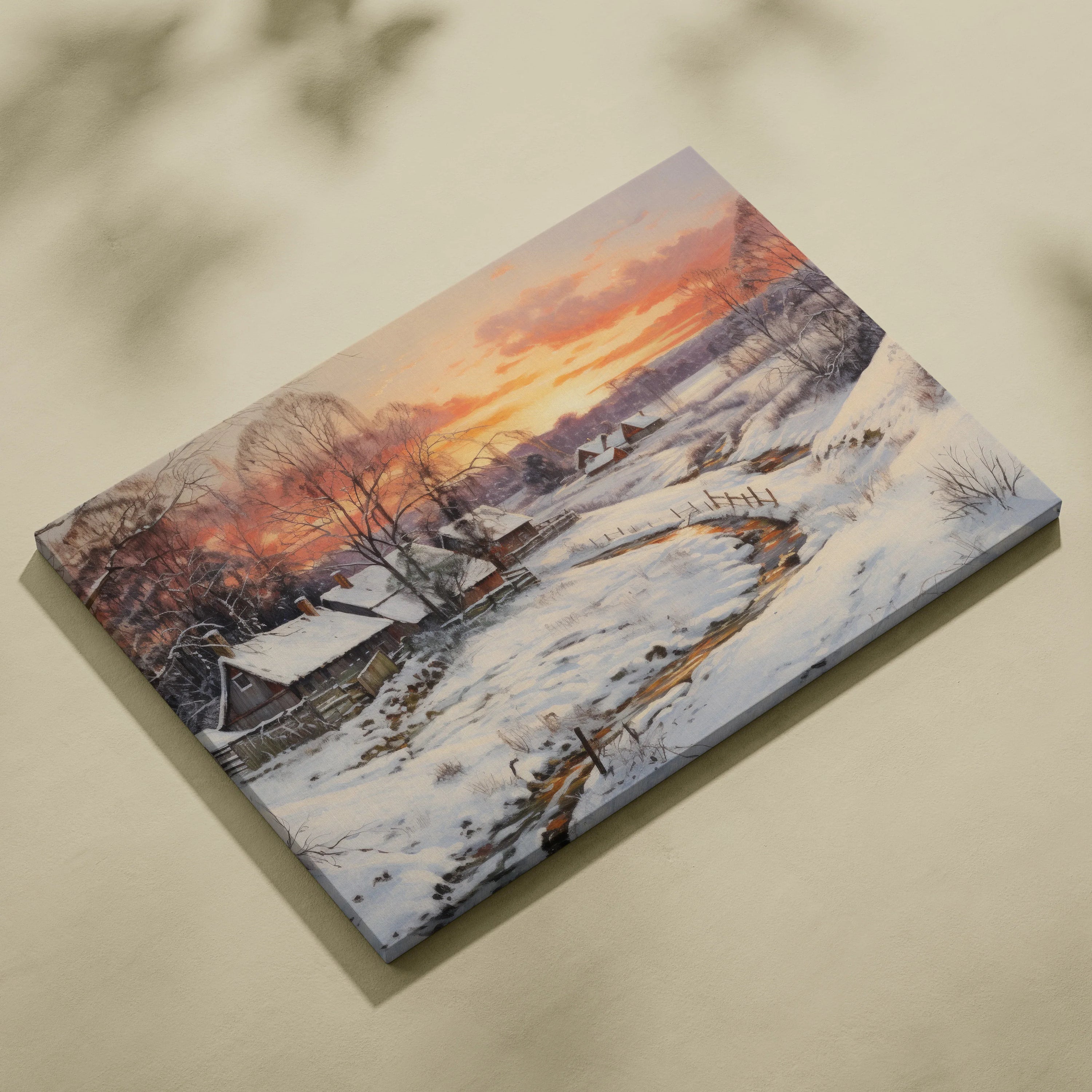 Canvas wall art featuring a snowy mountain landscape at sunset with vibrant orange and purple sky hues and a winding river.