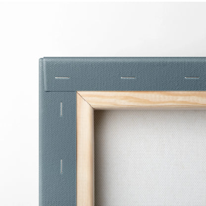 Close-up of stretched canvas corner with wooden frame and grey painted edges for wall art decor.