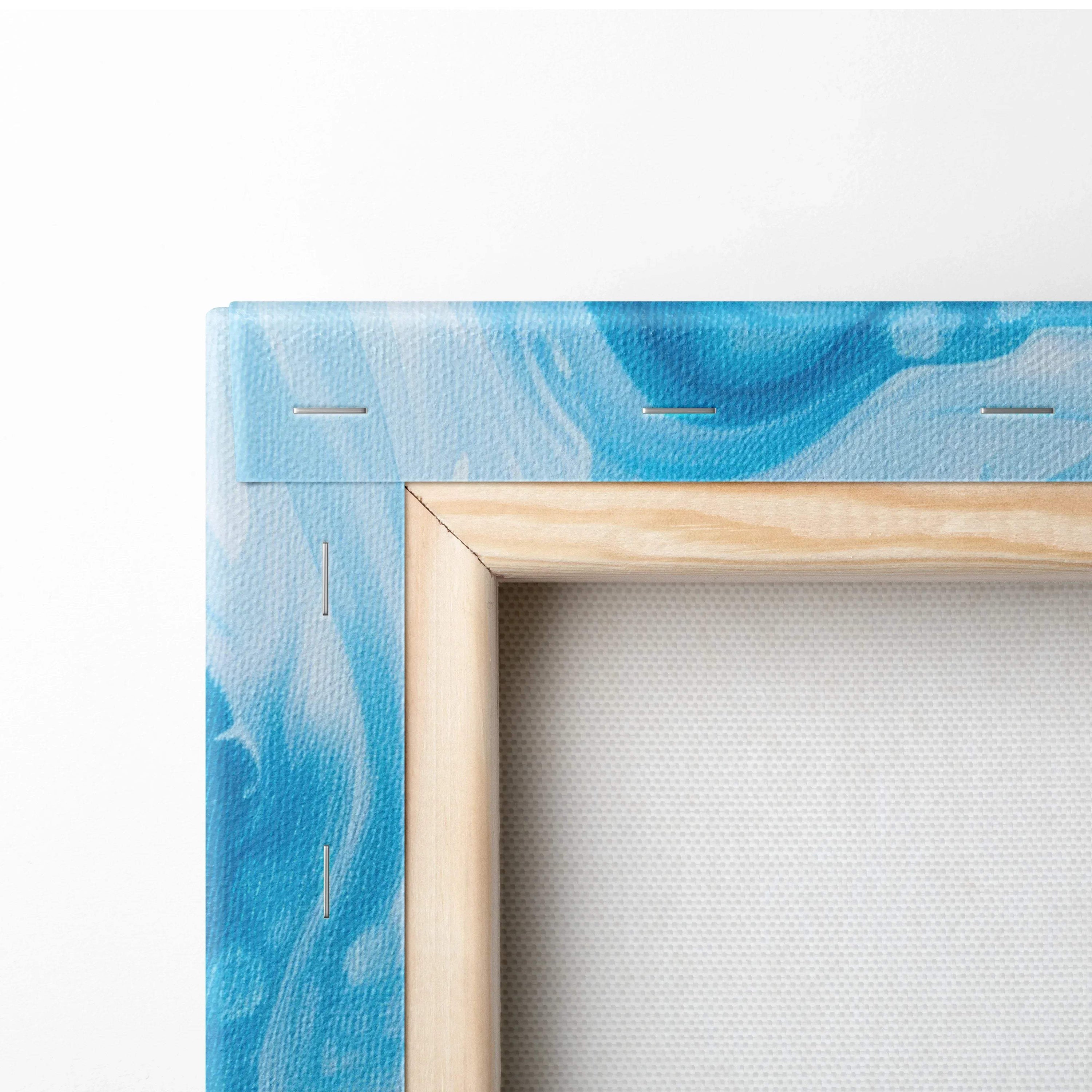 Close-up of wooden frame and blue abstract digital art on stretched canvas wall art.