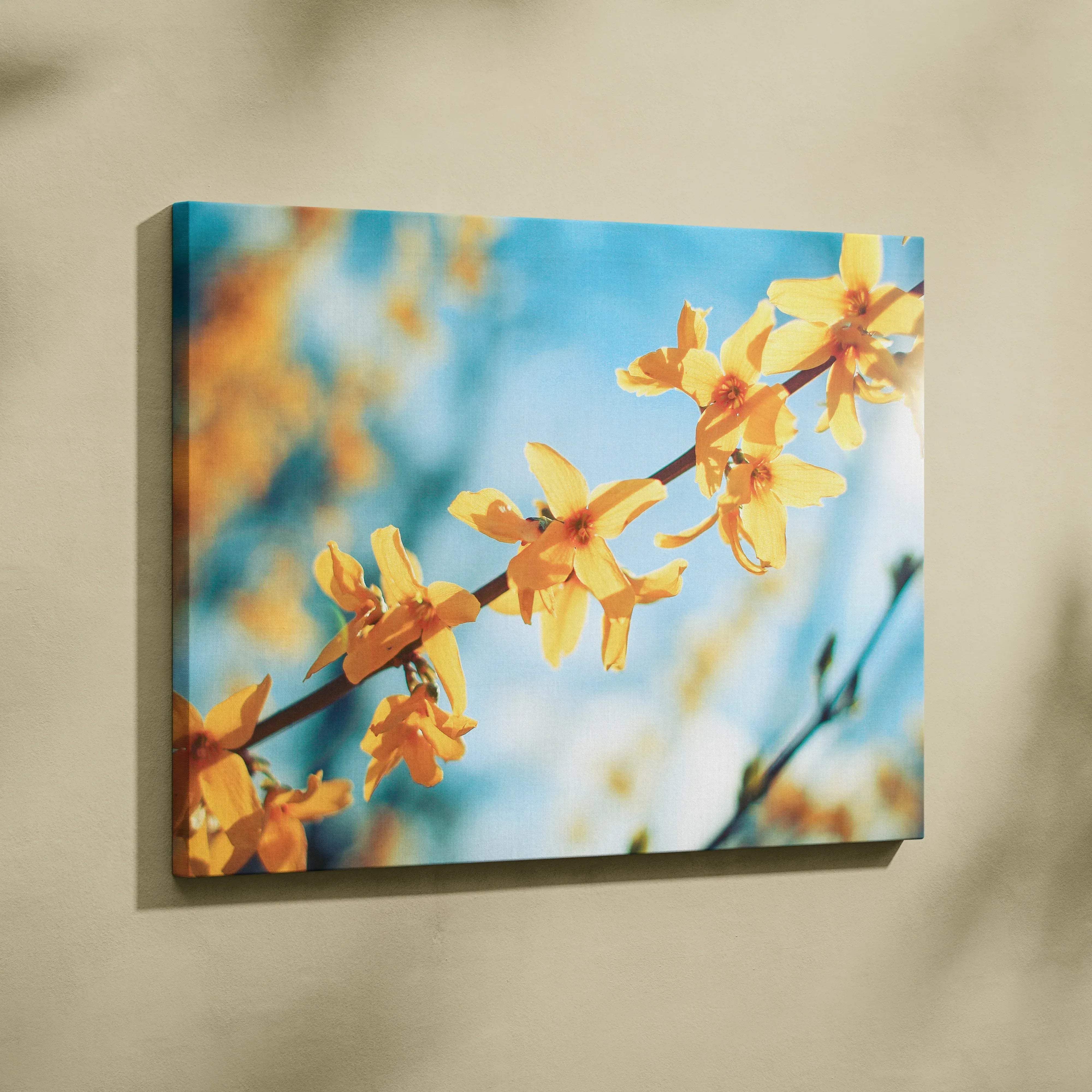 Rectangular canvas print featuring vibrant yellow forsythia blossoms against a soft blue sky for living room decor
