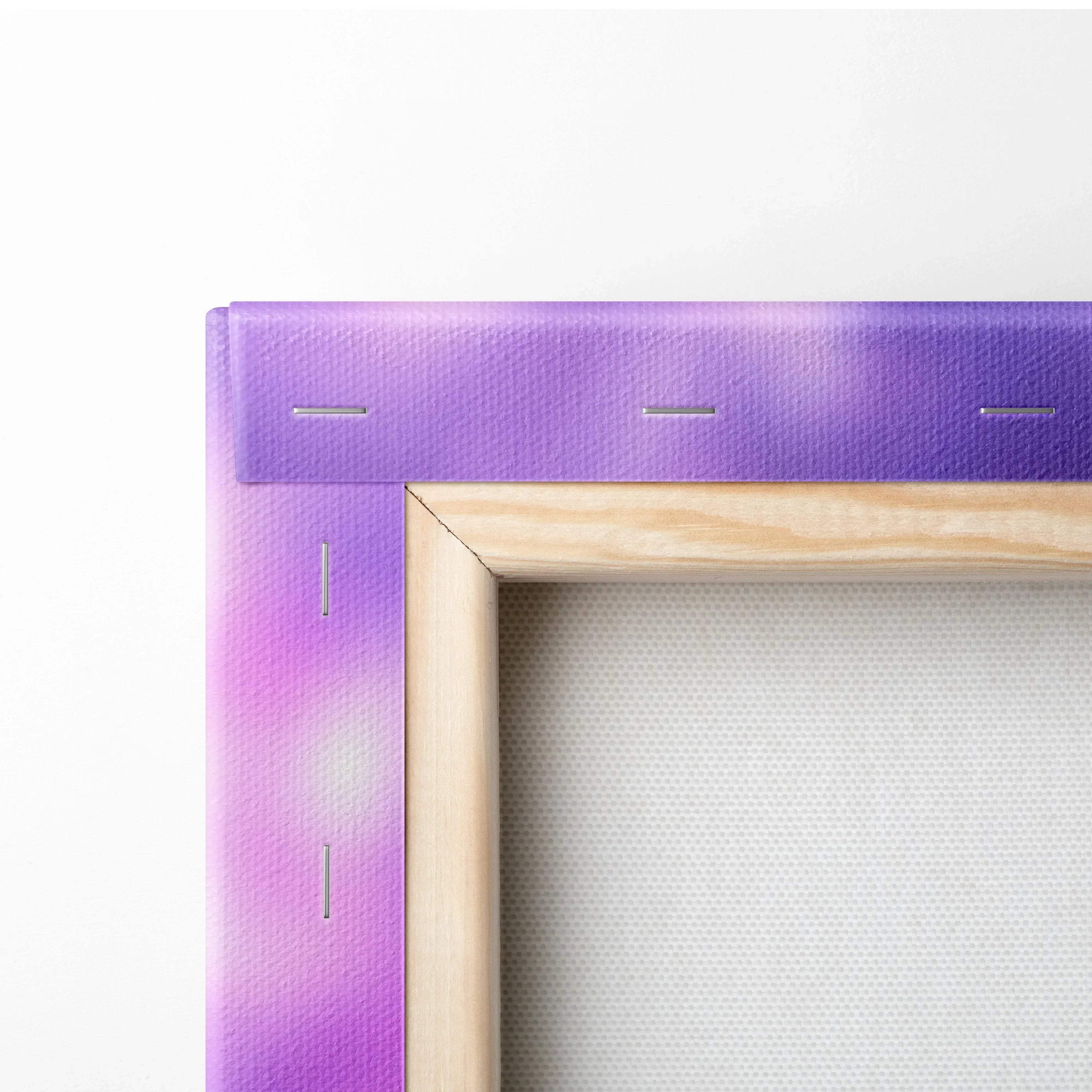 Close-up of stretched canvas art with purple and pink abstract design and wooden frame edges.