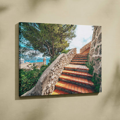 Canvas wall art featuring a rustic stone staircase with terracotta steps and lush greenery under a bright blue sky.