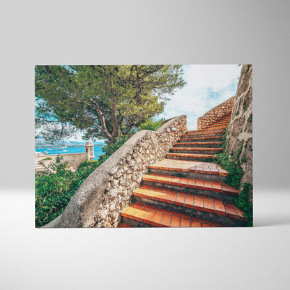 Canvas wall art featuring terracotta stairway with stone railing surrounded by greenery and distant water view.