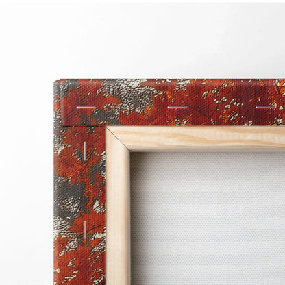 Close-up of canvas art corner with wooden frame showing autumn leaf pattern in red and orange tones on textured fabric wall.