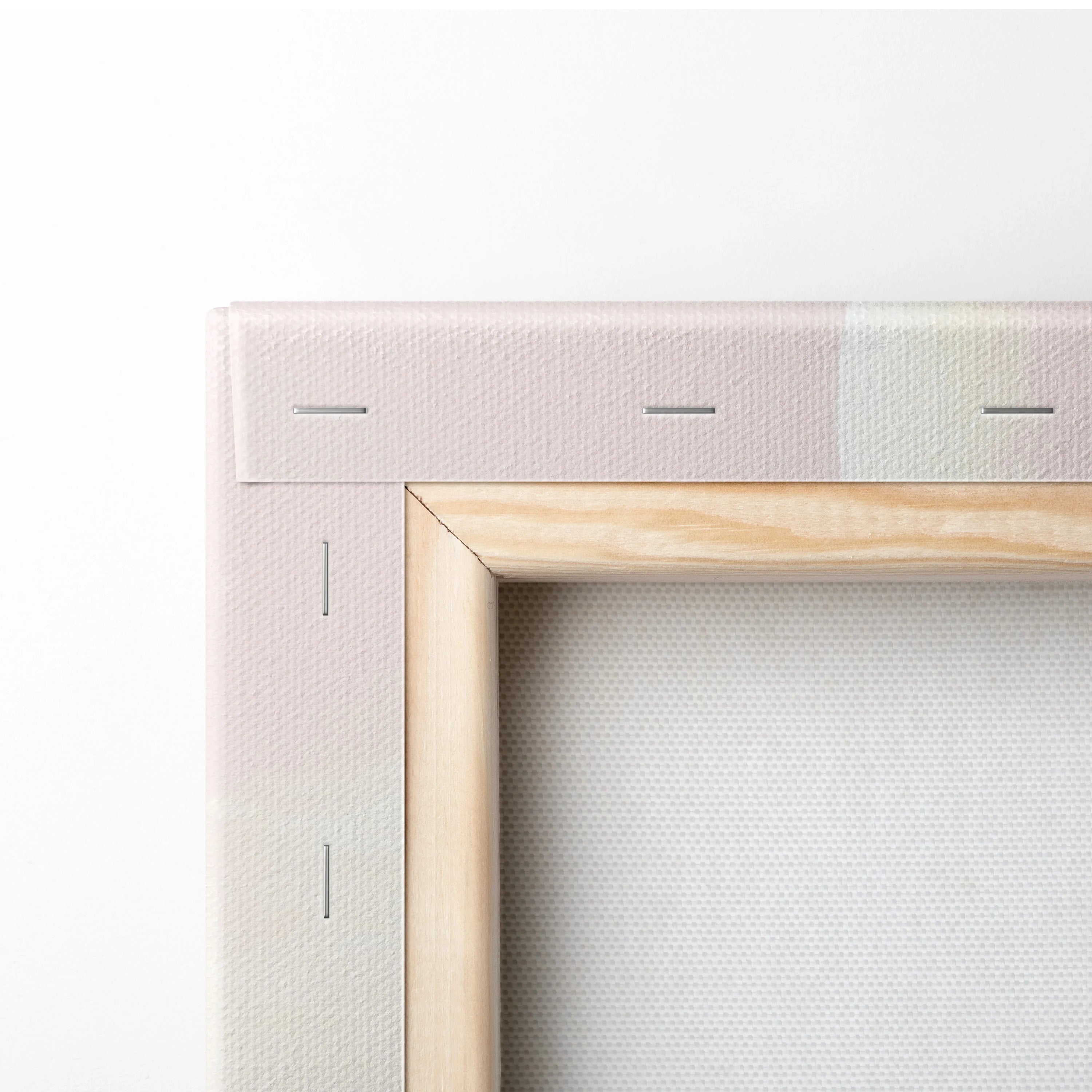 Corner detail of minimalist pink desert dunes digital canvas wall art with wooden frame and white decor background.