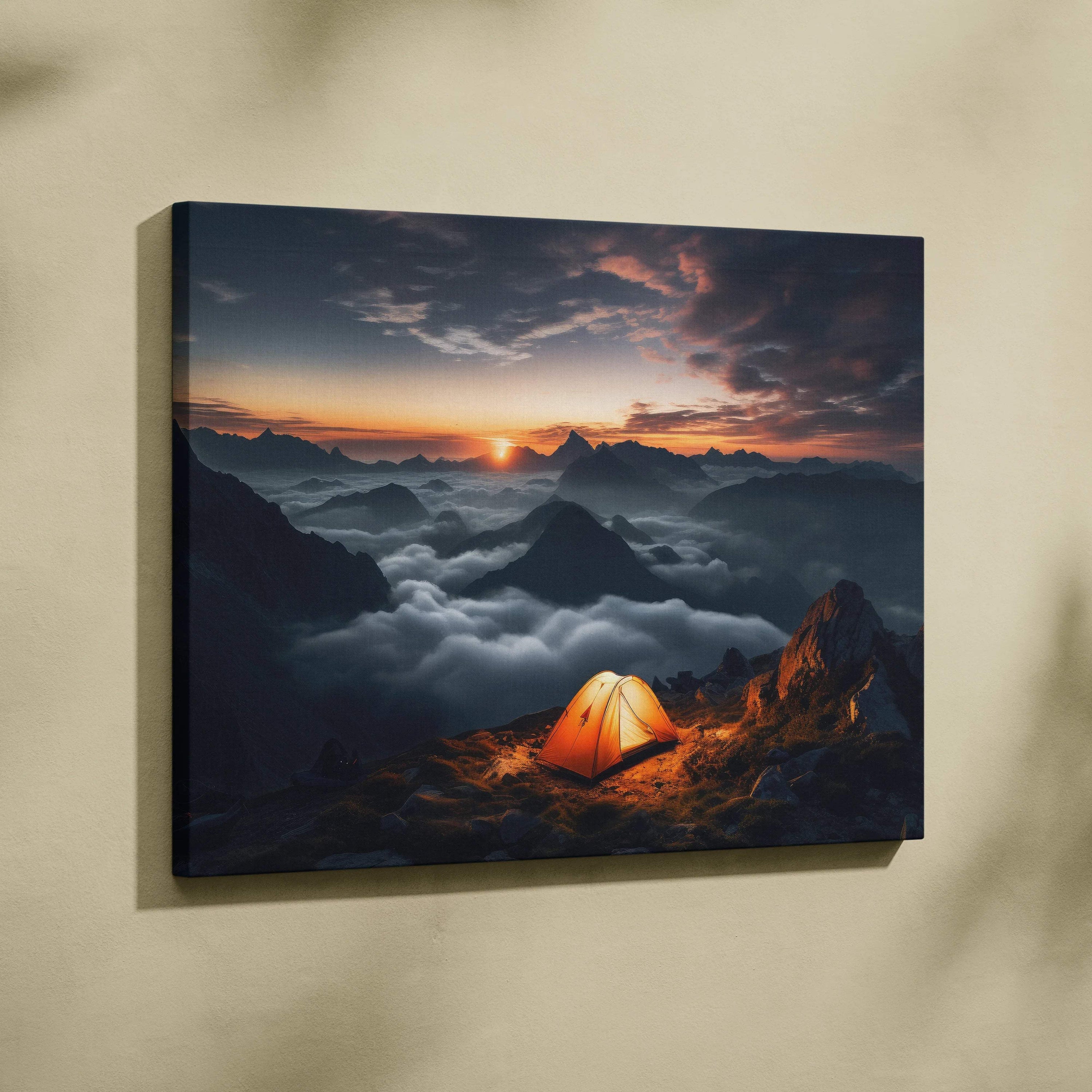 Glowing orange tent on mountain summit over clouds at sunset canvas print