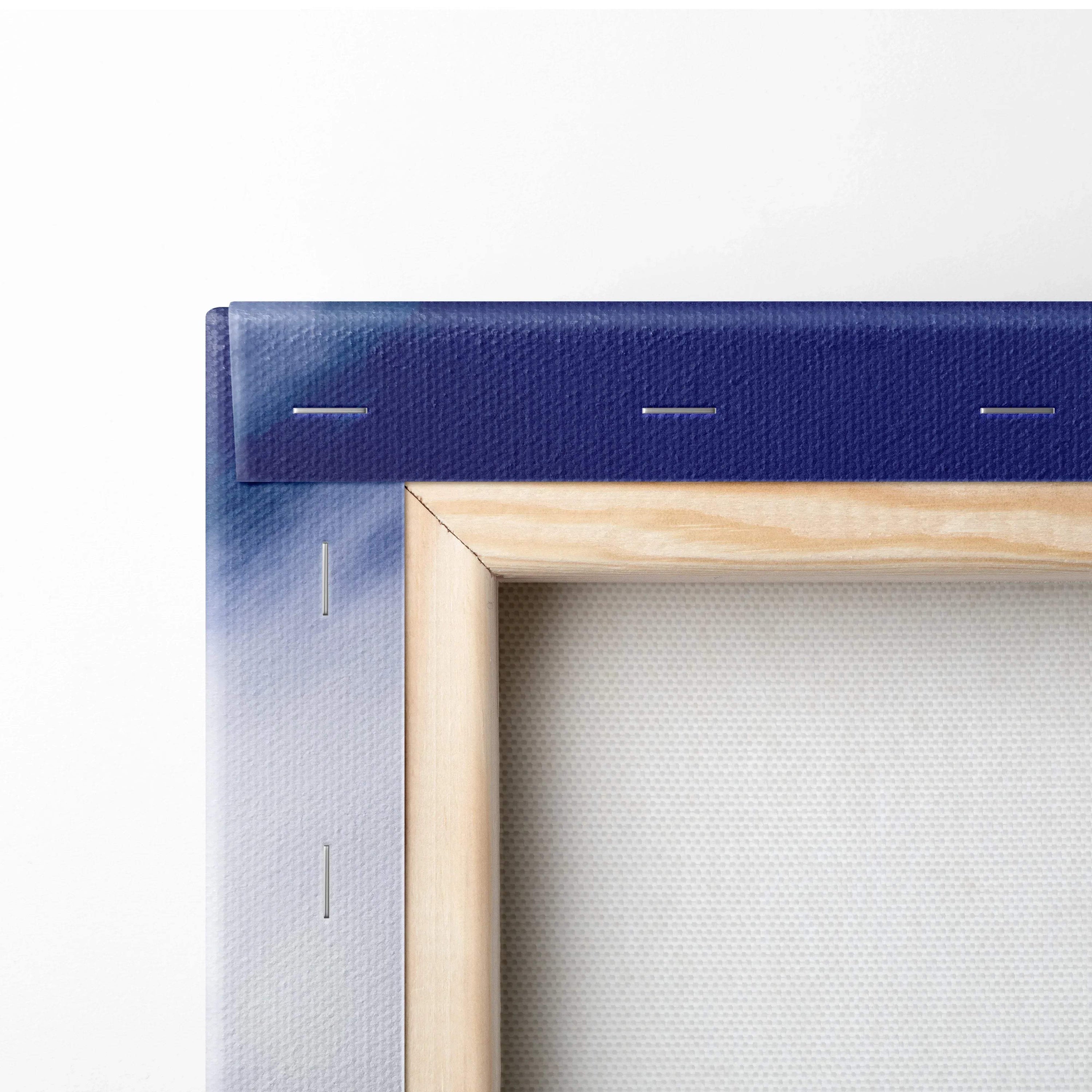 Close-up of a stretched canvas corner with visible wood frame and gradient blue to white paint on fabric edge.