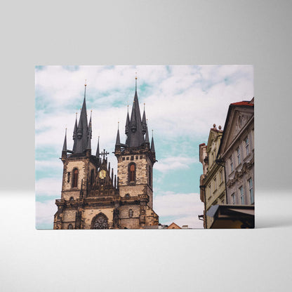 Canvas wall art featuring gothic cathedral spires against a blue sky with clouds.