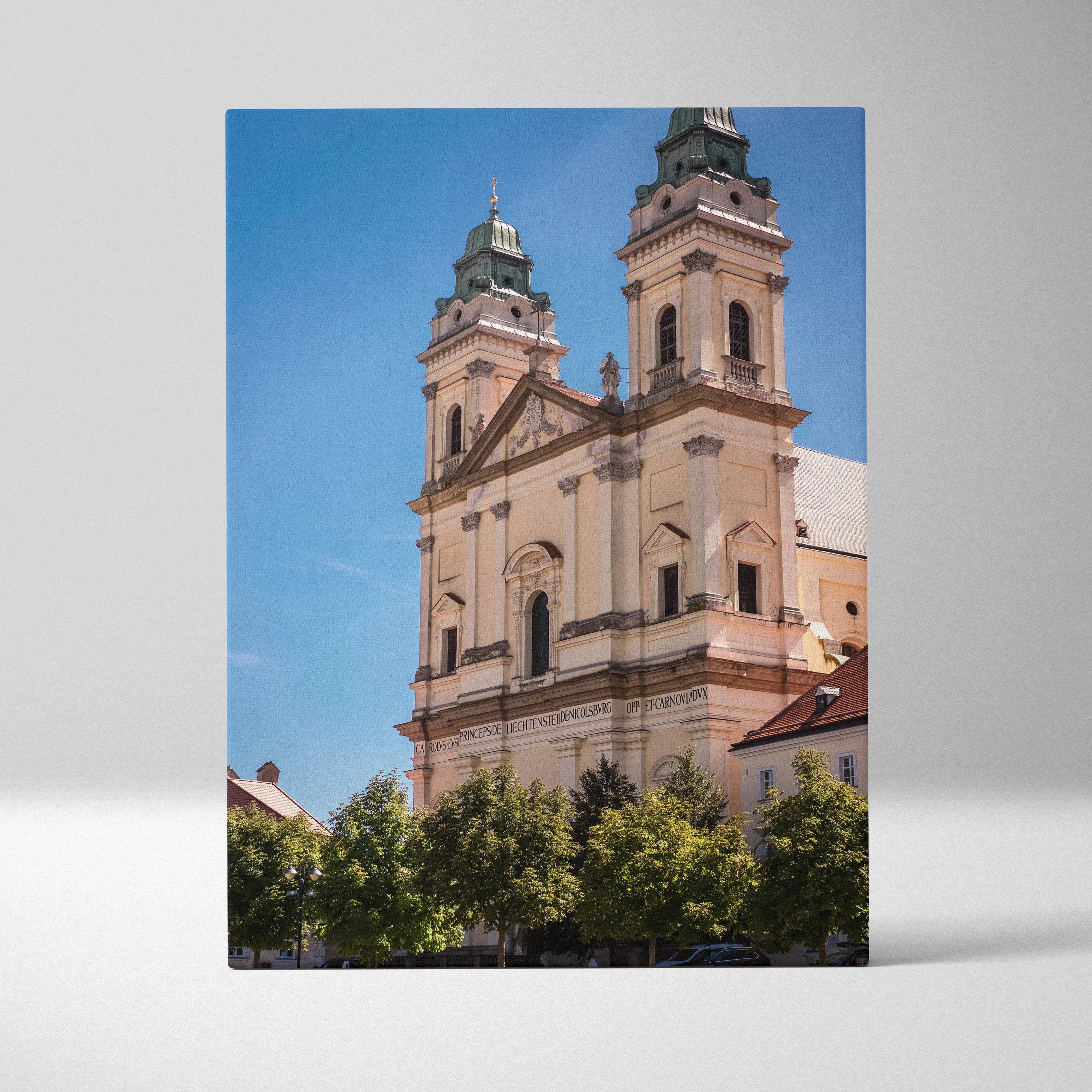 Elegant architecture canvas wall art featuring a beige stone church with green towers under bright blue sky