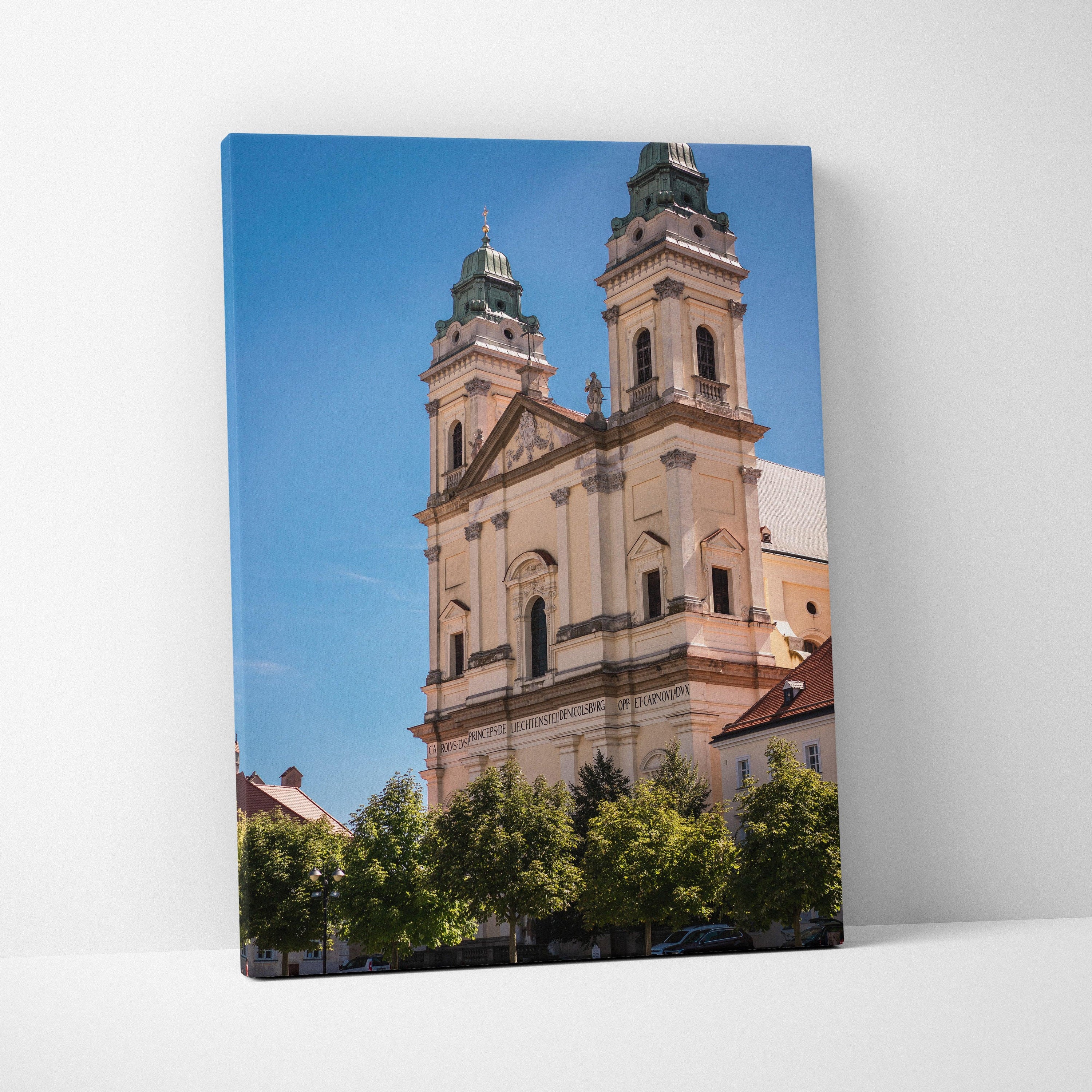 Canvas wall art featuring beige historic twin-towered building against a clear blue sky with trees at the base.