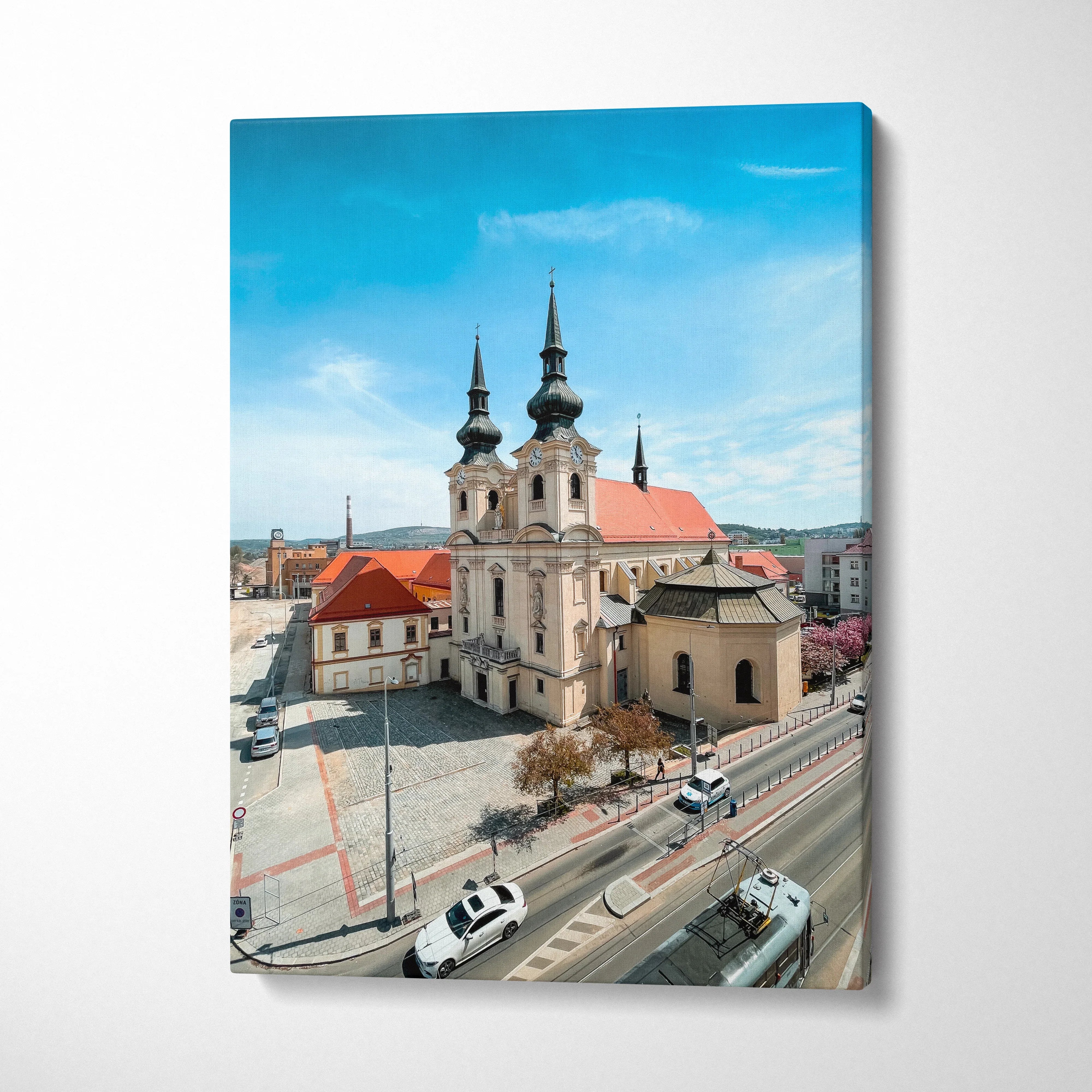 Canvas art of historic urban church with twin spires under bright blue sky, wall art for home or office.