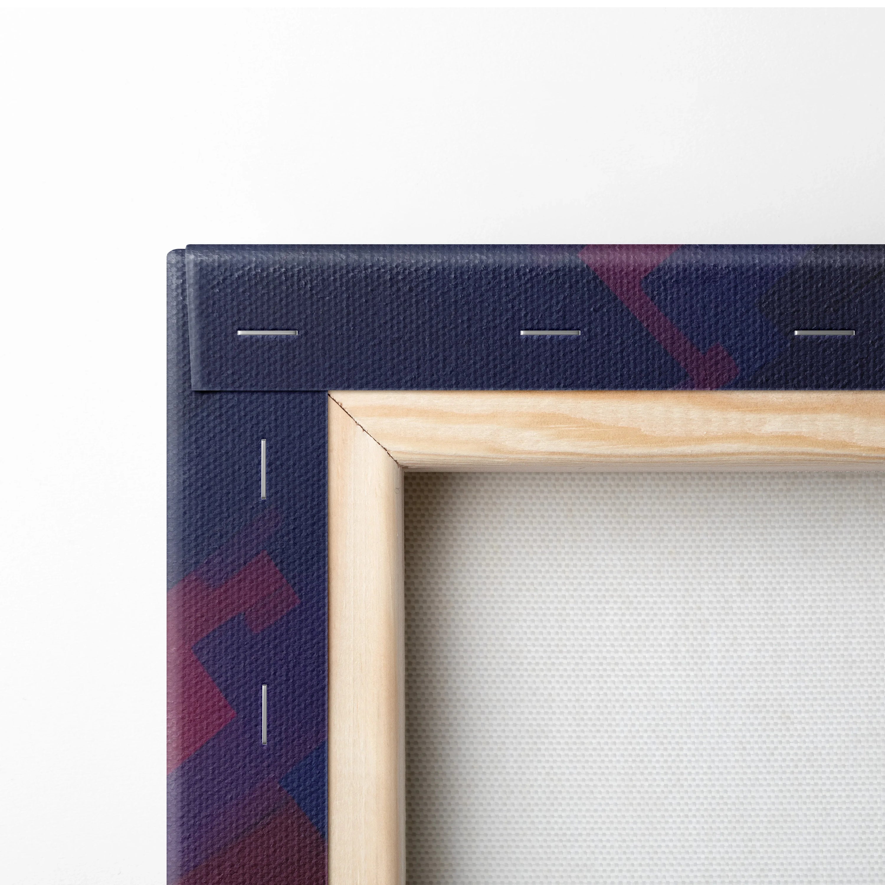 Close-up of canvas art corner showing natural wood frame and dark canvas edge with red abstract design for wall art.