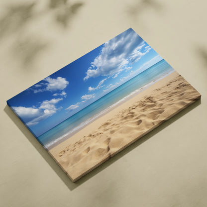 Canvas wall art depicting a sandy beach with golden sand and ocean waves under a bright blue sky with scattered white clouds.