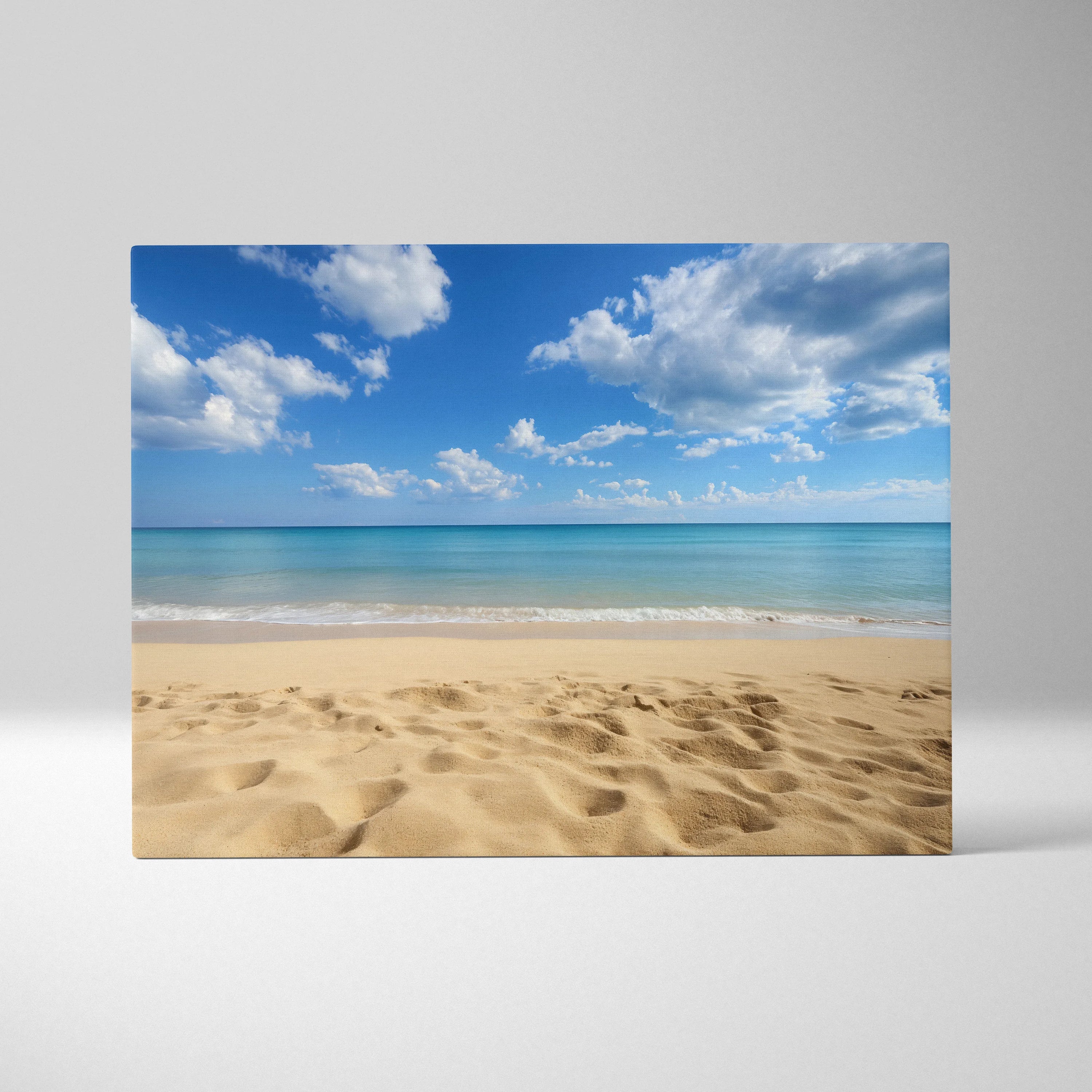 Canvas wall art featuring golden sandy beach and calm ocean waves under a bright blue sky with scattered white clouds.