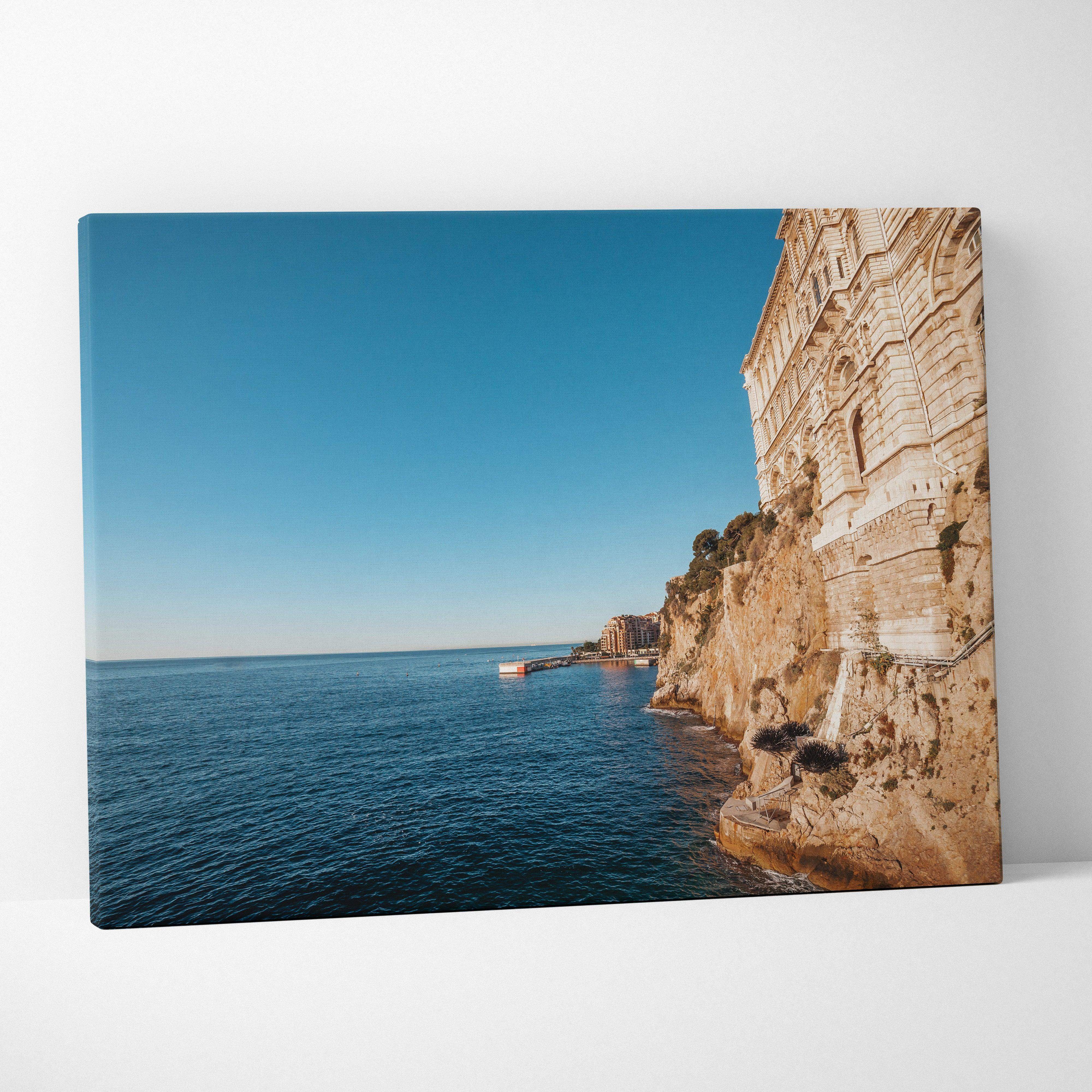 Canvas print of Monaco cliffside building, ocean, and clear sky