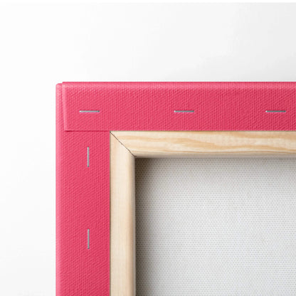 Close-up of natural wood frame with pink colored canvas stretched and stapled on back for wall art decor.