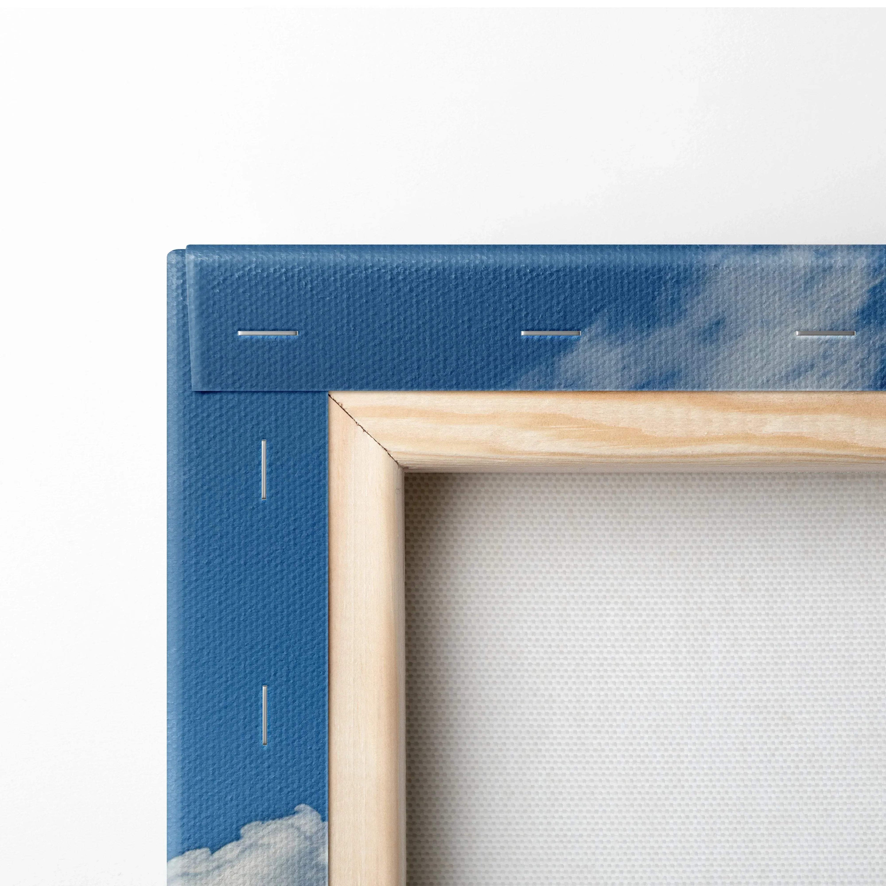 Corner detail of blue floral mountain landscape canvas wall art with natural wood frame and visible staples for decor.