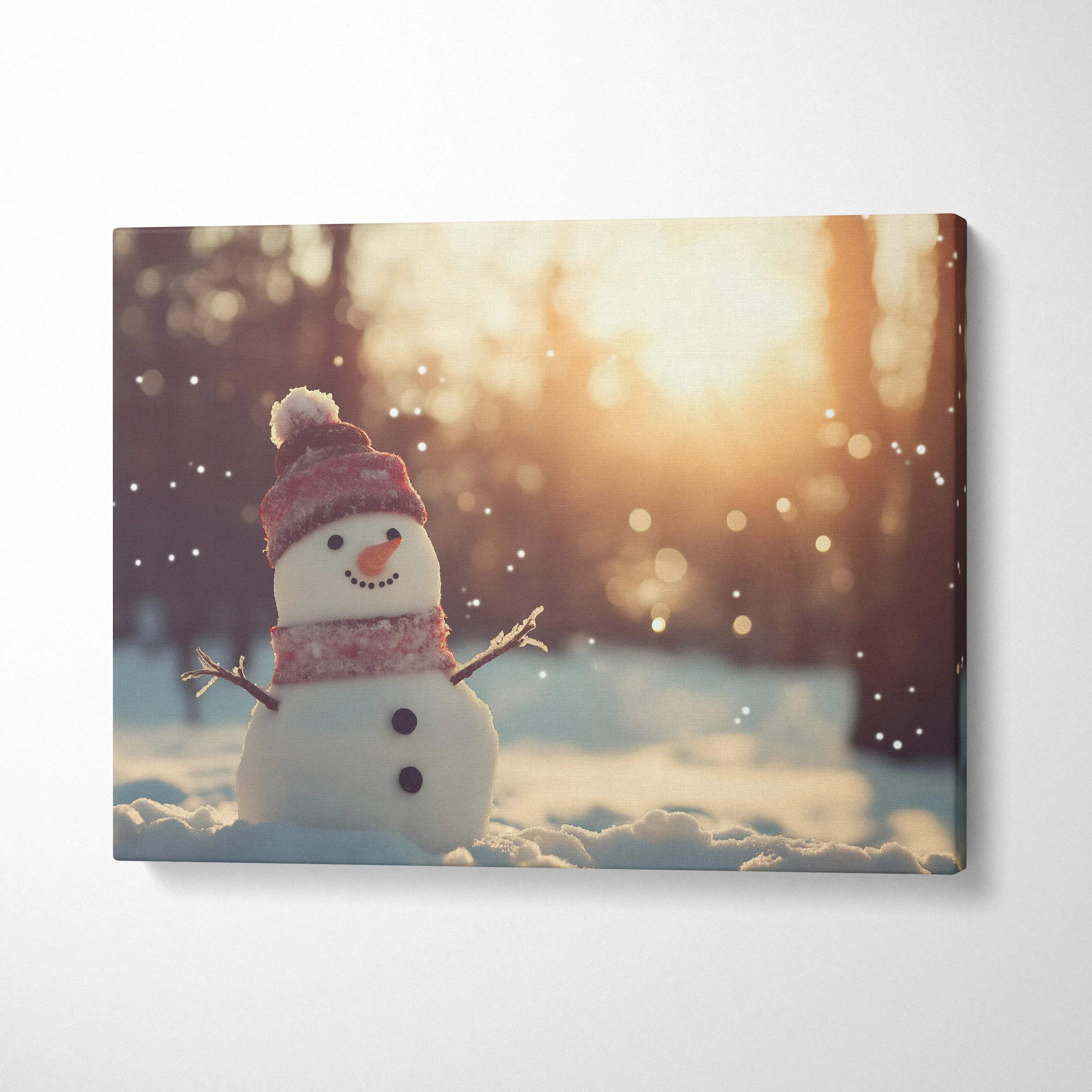 Canvas wall art featuring a cute snowy snowman in soft sunset light with falling snowflakes decor.