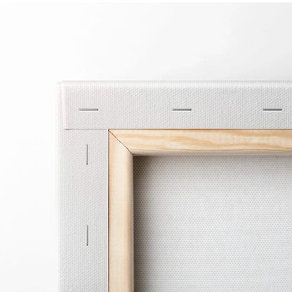 Close-up of stretched blank white canvas art with wooden frame and visible staples on back for wall art display.