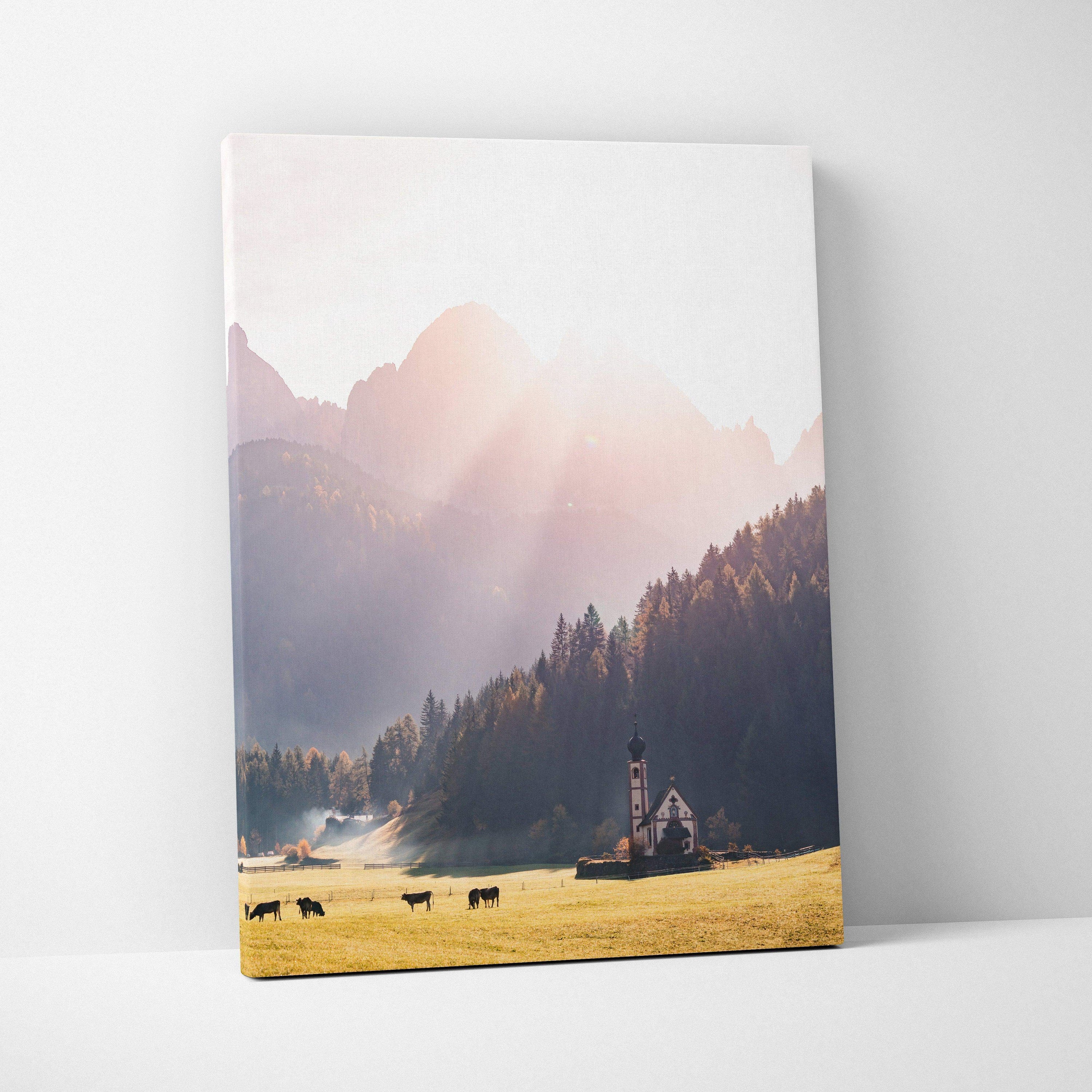 Vertical canvas art of autumn mountains with sunrays, forest, and a small church wall art.