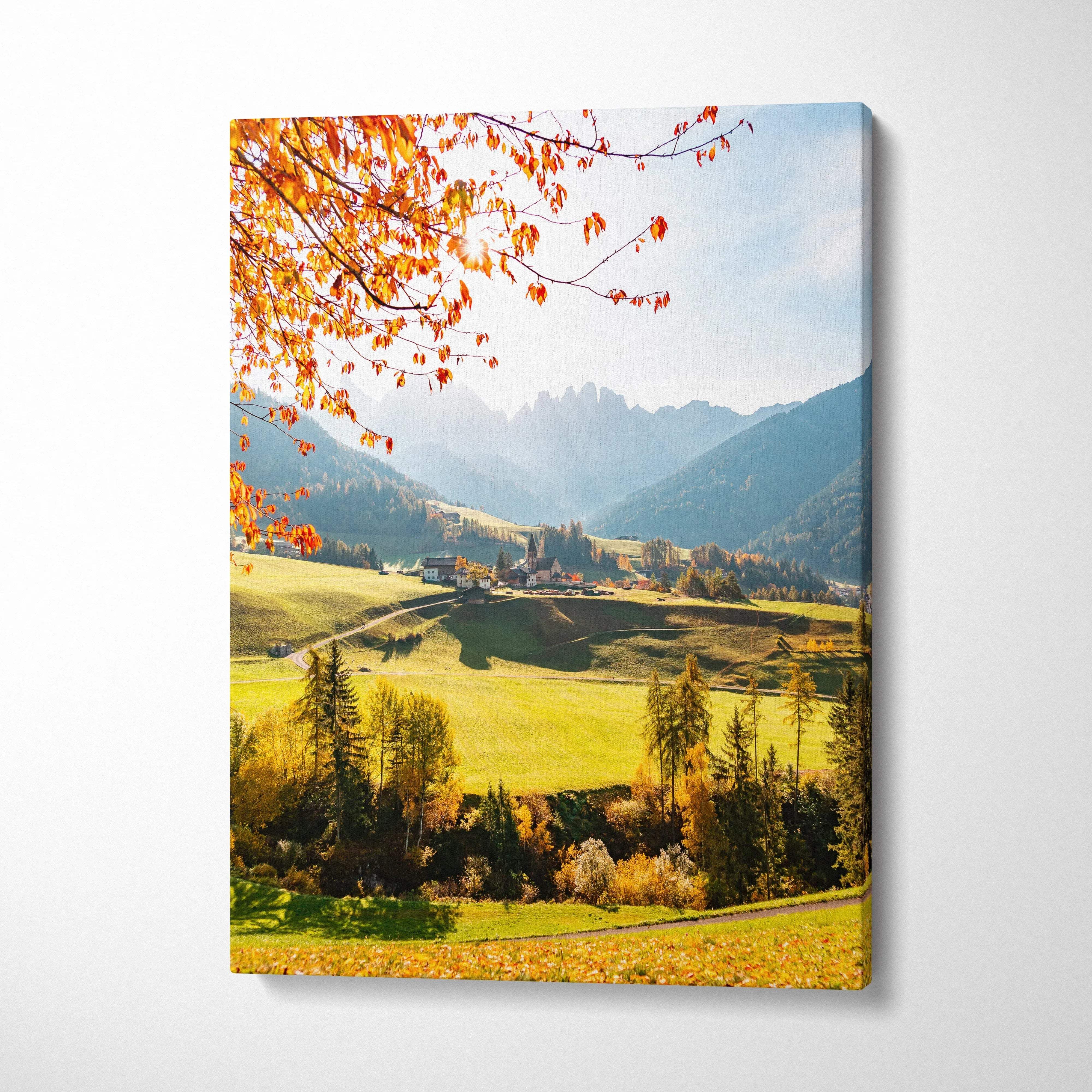 Vertical canvas wall art featuring vibrant autumn leaves over a sunlit mountain valley landscape.