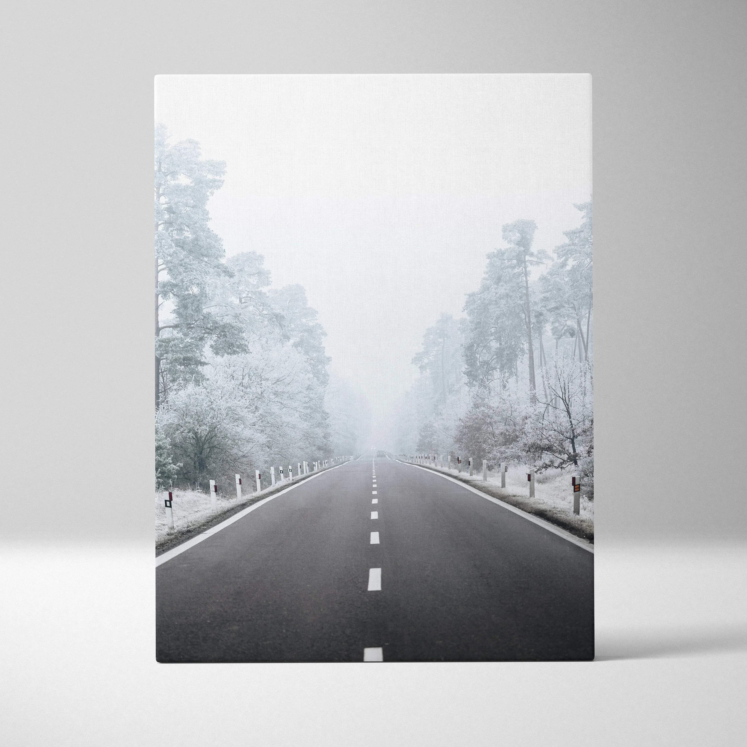 Serene winter road scene on canvas wall art with snowy trees and mist for home decor.