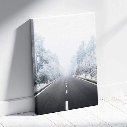 Canvas wall art featuring a snowy road flanked by frost-covered trees in a serene winter landscape.