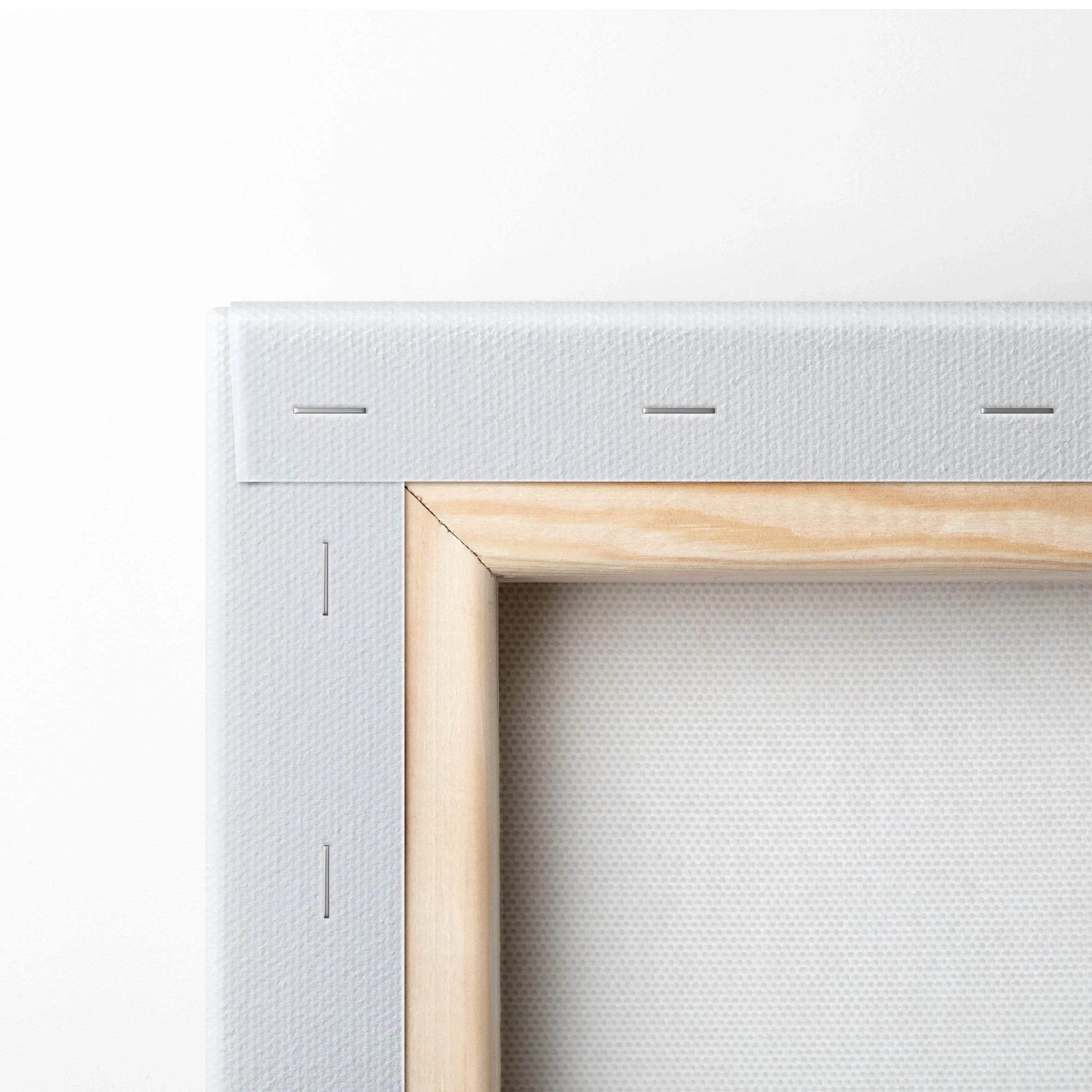 Close-up of wooden frame and white canvas stretched and stapled for wall art decor.