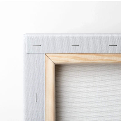Close-up of wooden frame and white canvas stretched and stapled for wall art decor.