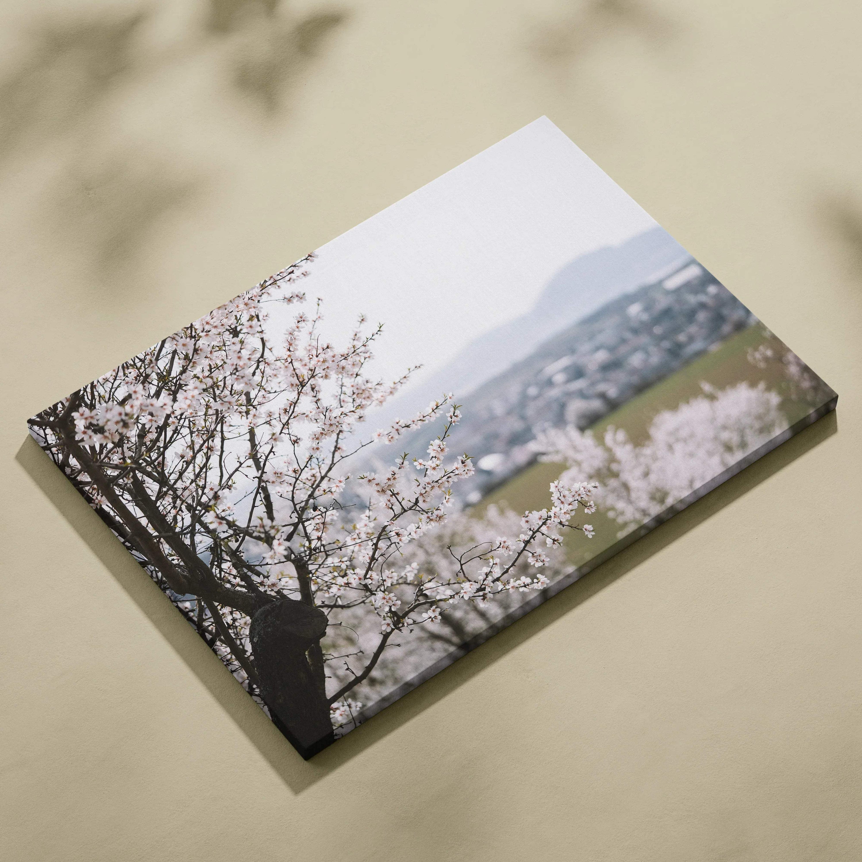 Horizontal cherry blossom canvas wall art with soft pink flowers and distant mountain decor.