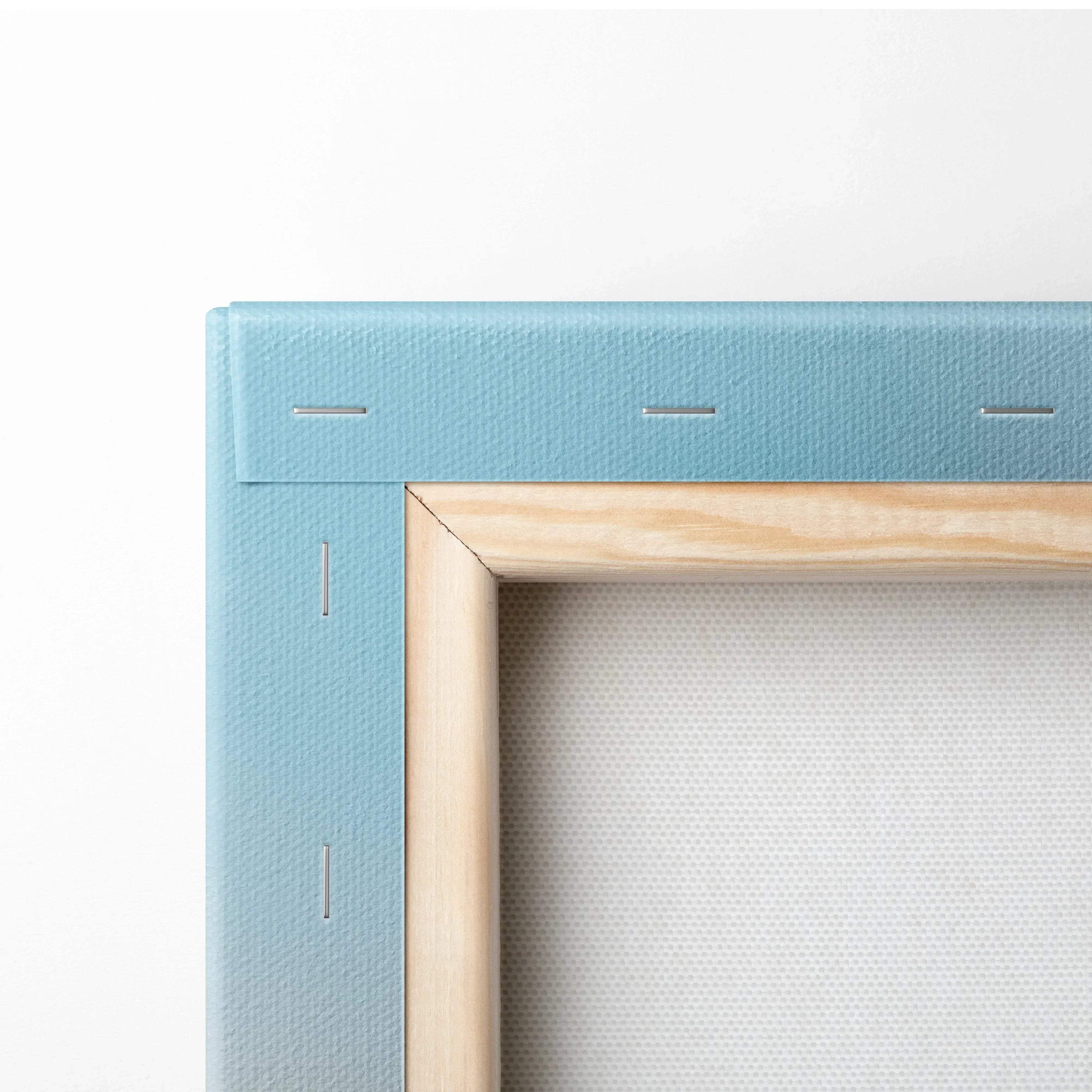 Close-up of wooden frame corner with blue canvas backing on wall art decor.