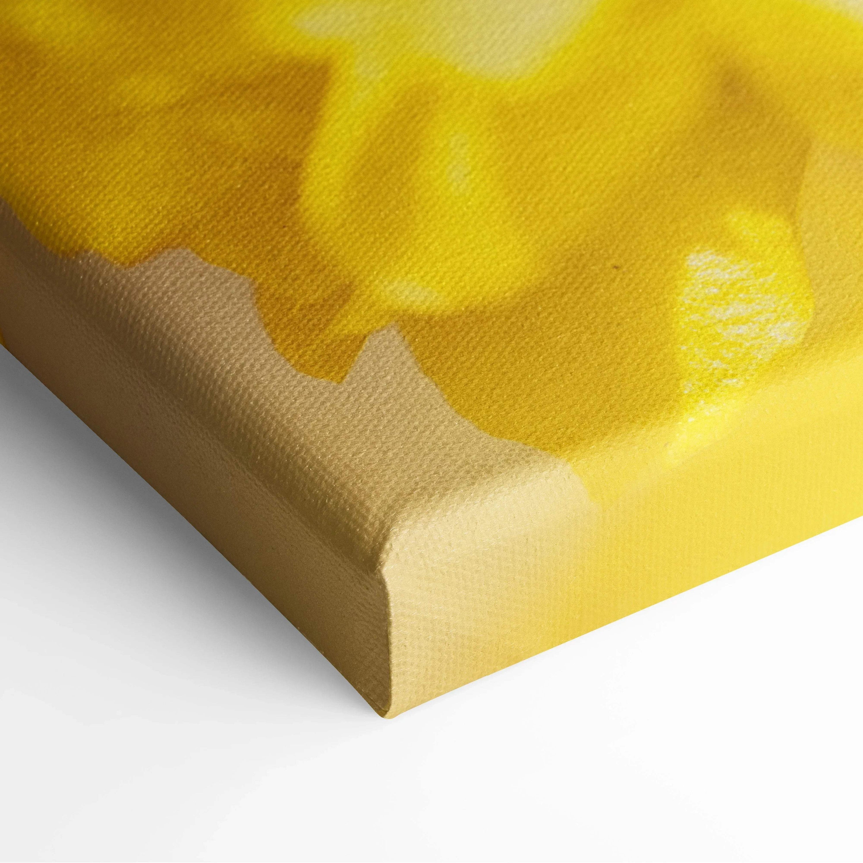 Yellow floral canvas wall art with soft petals, vibrant decor detail on stretched frame.