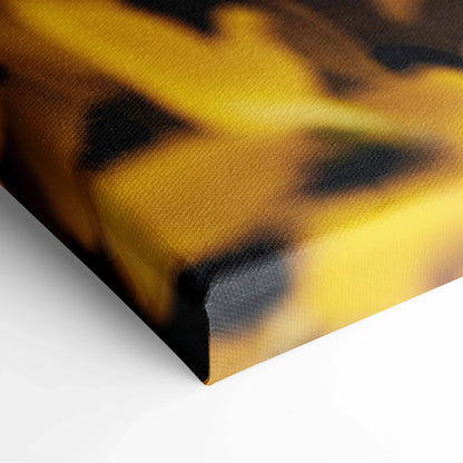 Close-up of canvas wall art featuring yellow and black abstract floral decor with textured surface.
