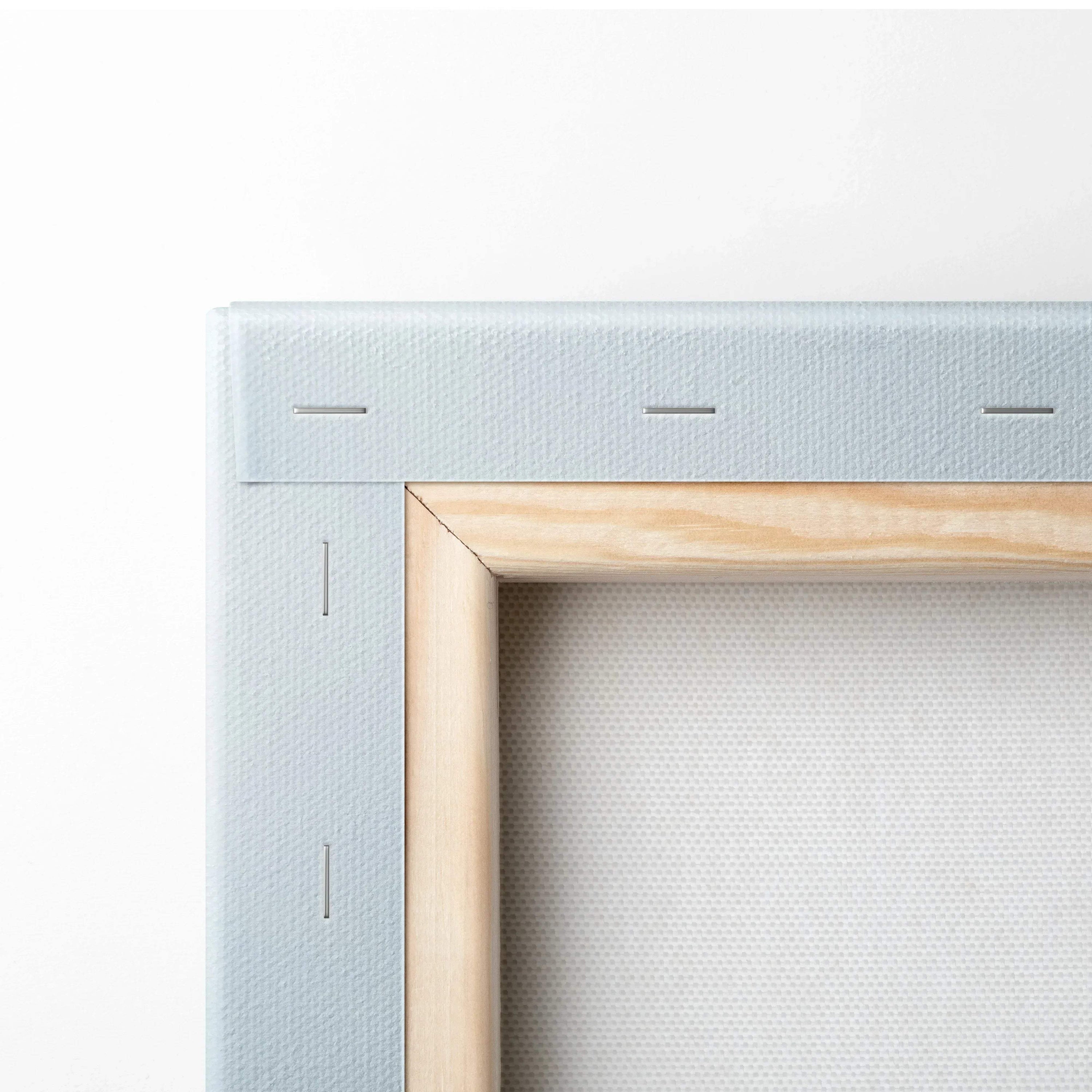 Close-up of white stretched canvas with wooden frame and staples for wall art decor.