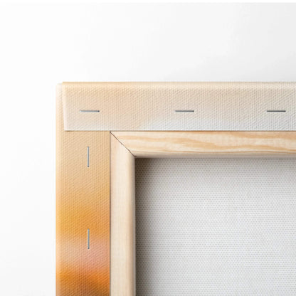 Close-up of wooden canvas frame corner with stretched white canvas and visible staples for wall art mounting.