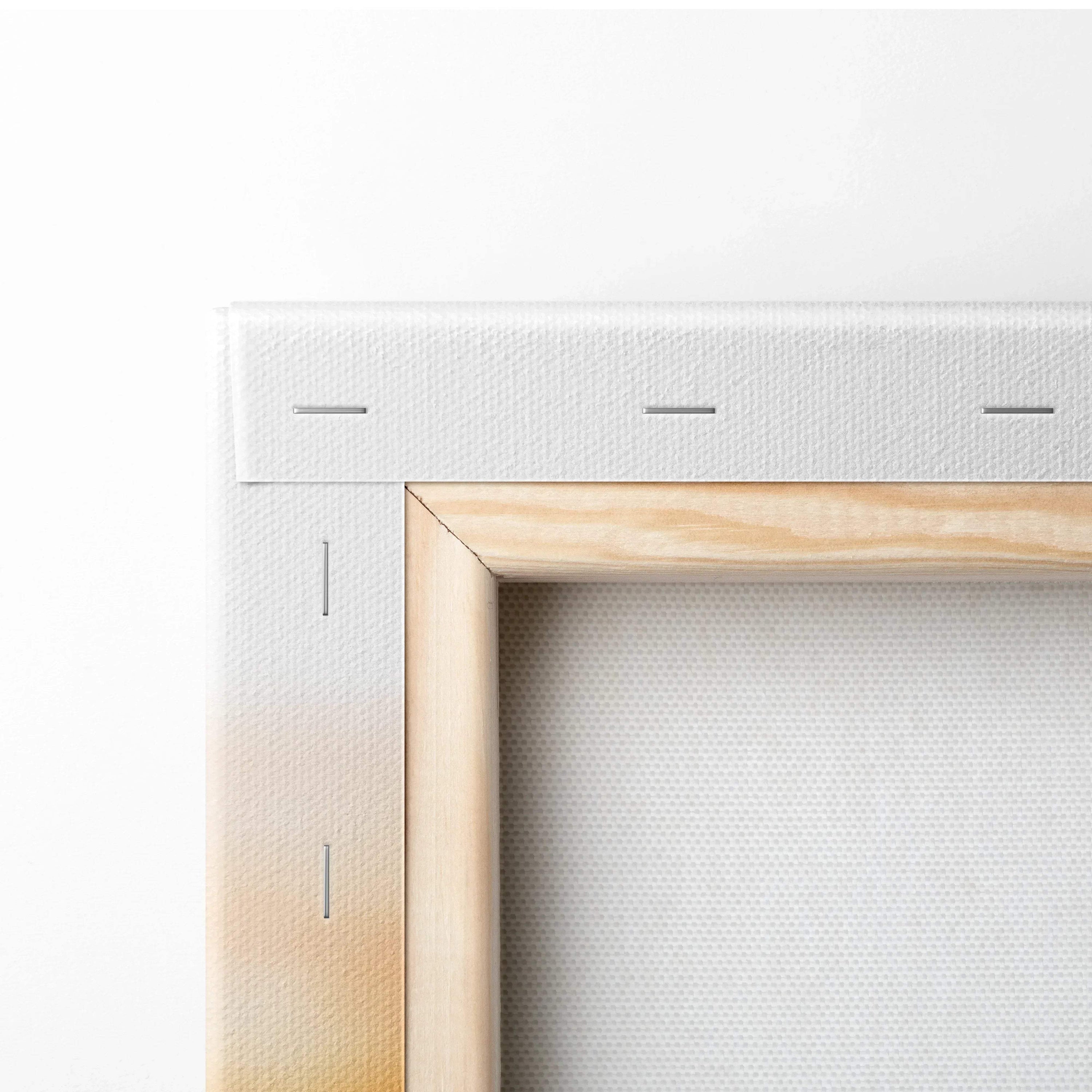 Close-up of wooden frame and white stretched canvas for wall art print.