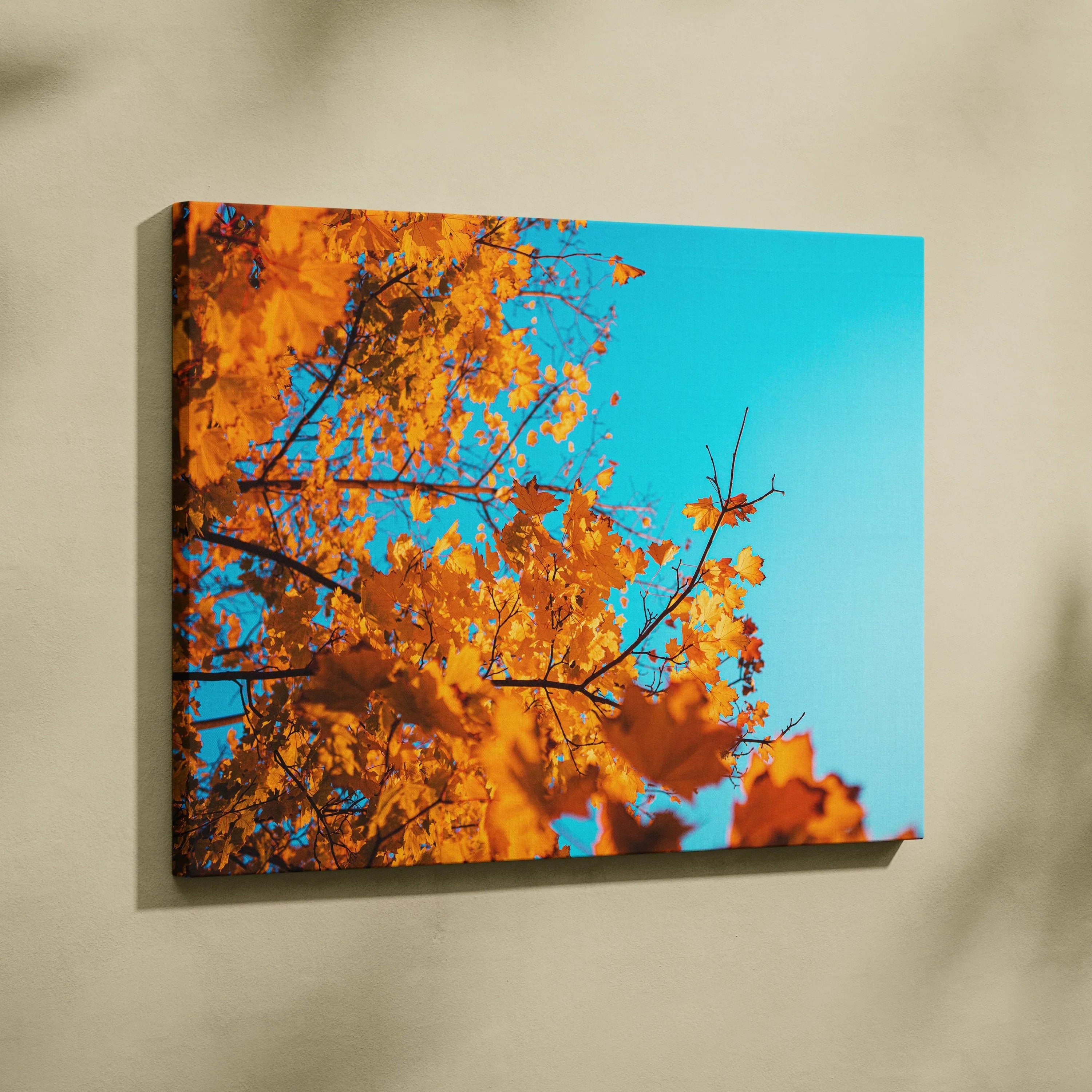 Canvas wall art featuring vibrant golden autumn leaves against a bright blue sky.