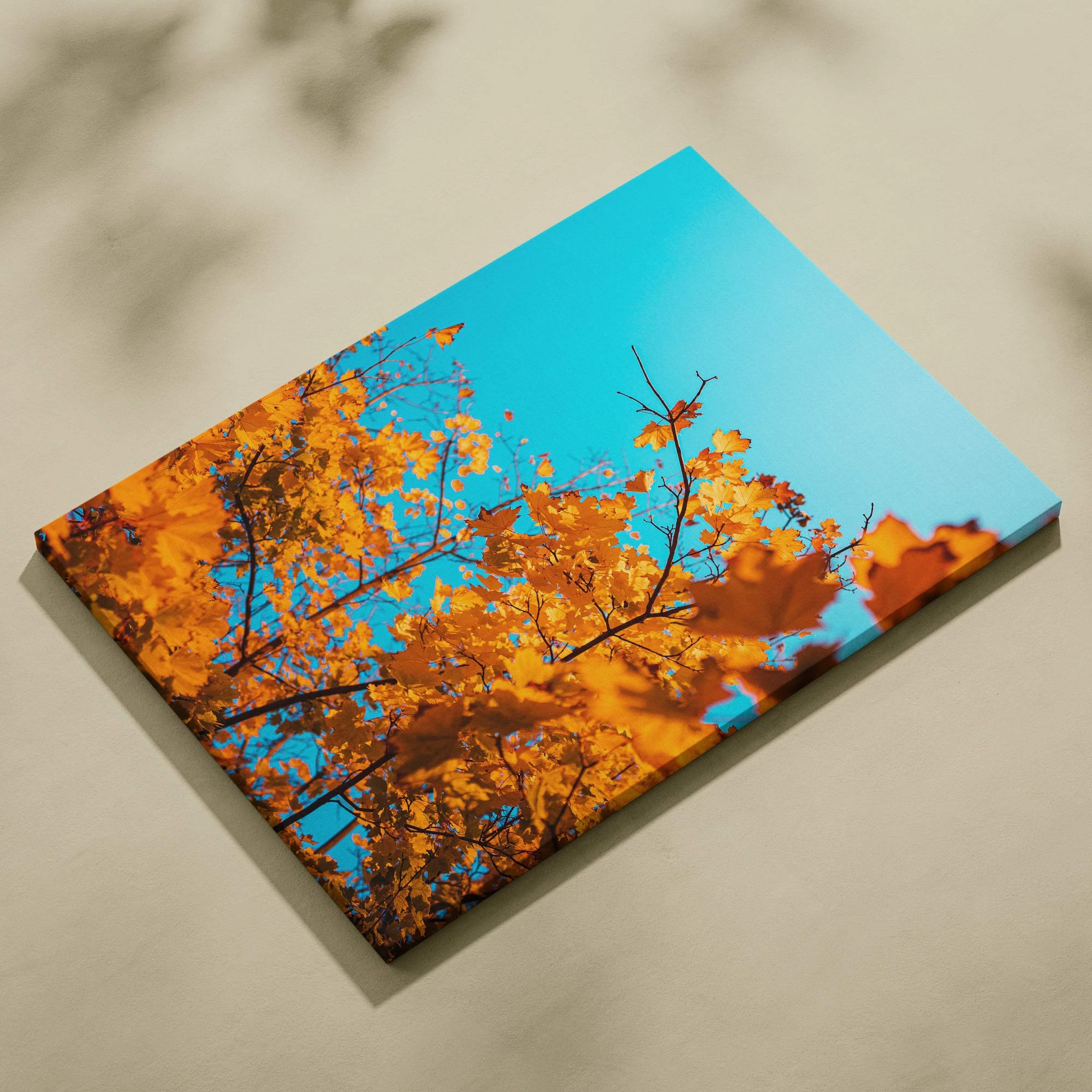 Autumn nature canvas wall art with golden leaves against bright blue sky.
