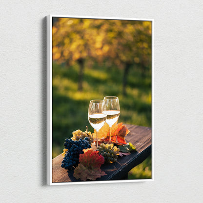 Canvas wall art featuring two wine glasses, clusters of grapes, and autumn leaves on a wooden surface with a blurred.