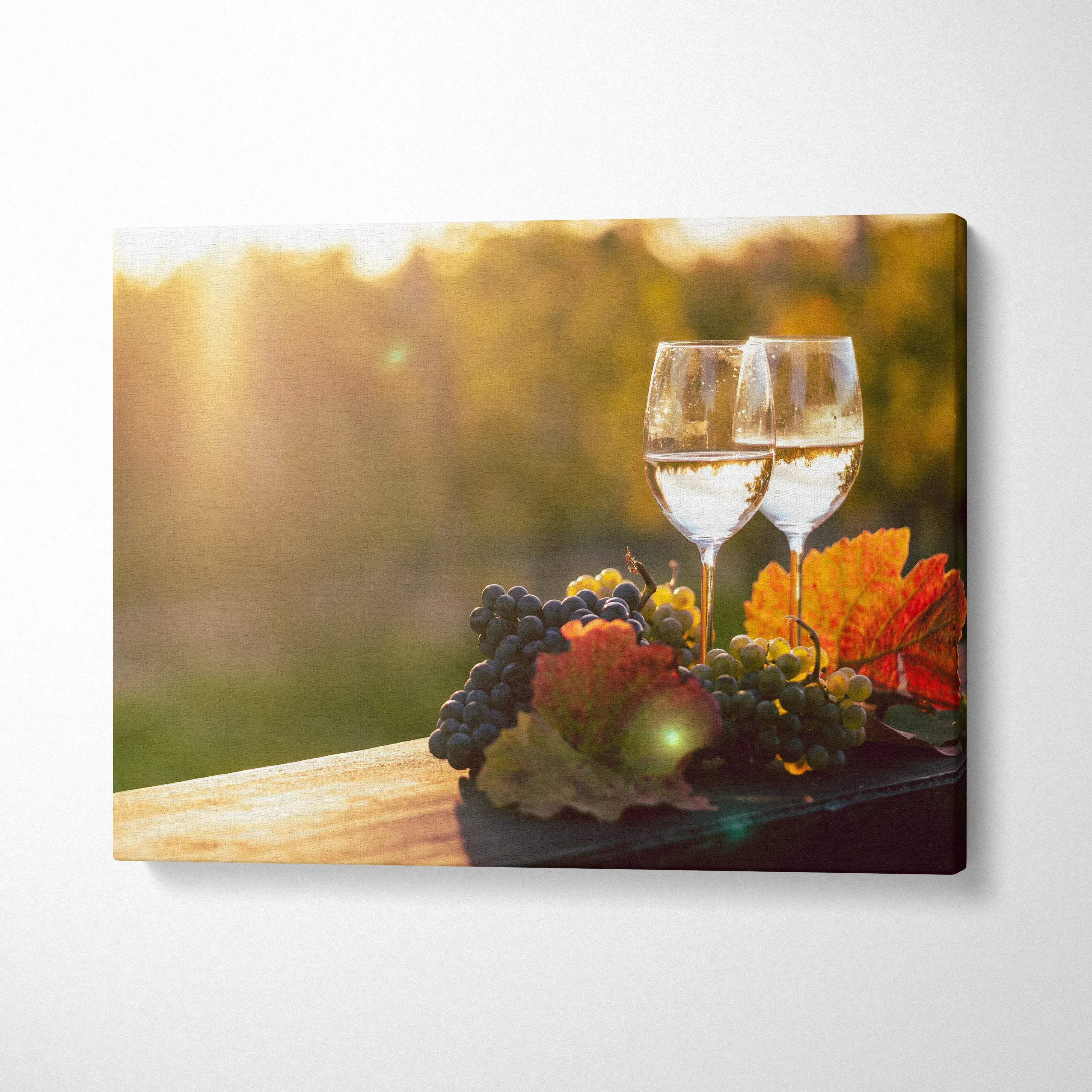 Canvas wall art featuring wine glasses, grapes, and autumn leaves in warm sunlight decor.