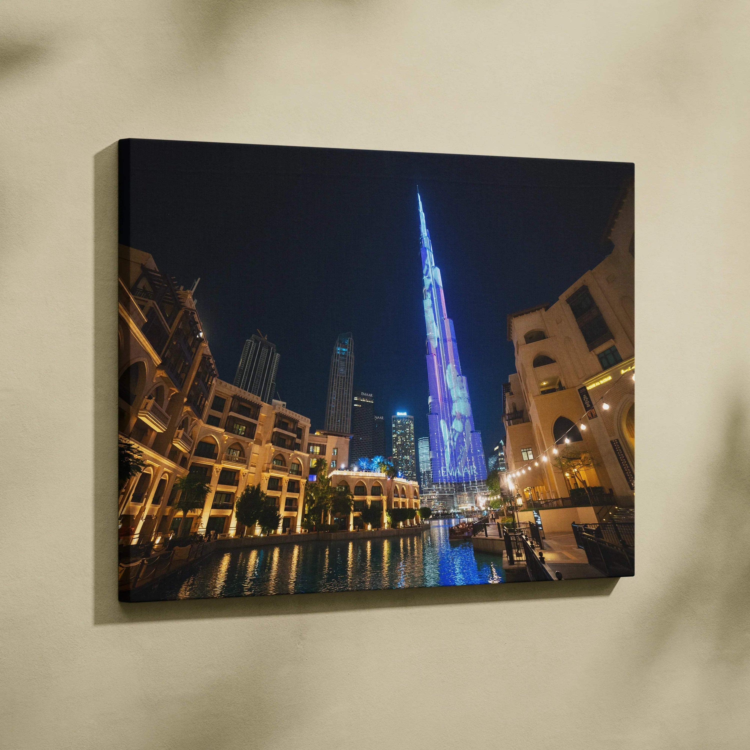 High-resolution canvas wall art of illuminated modern skyscrapers and buildings at night with reflections.