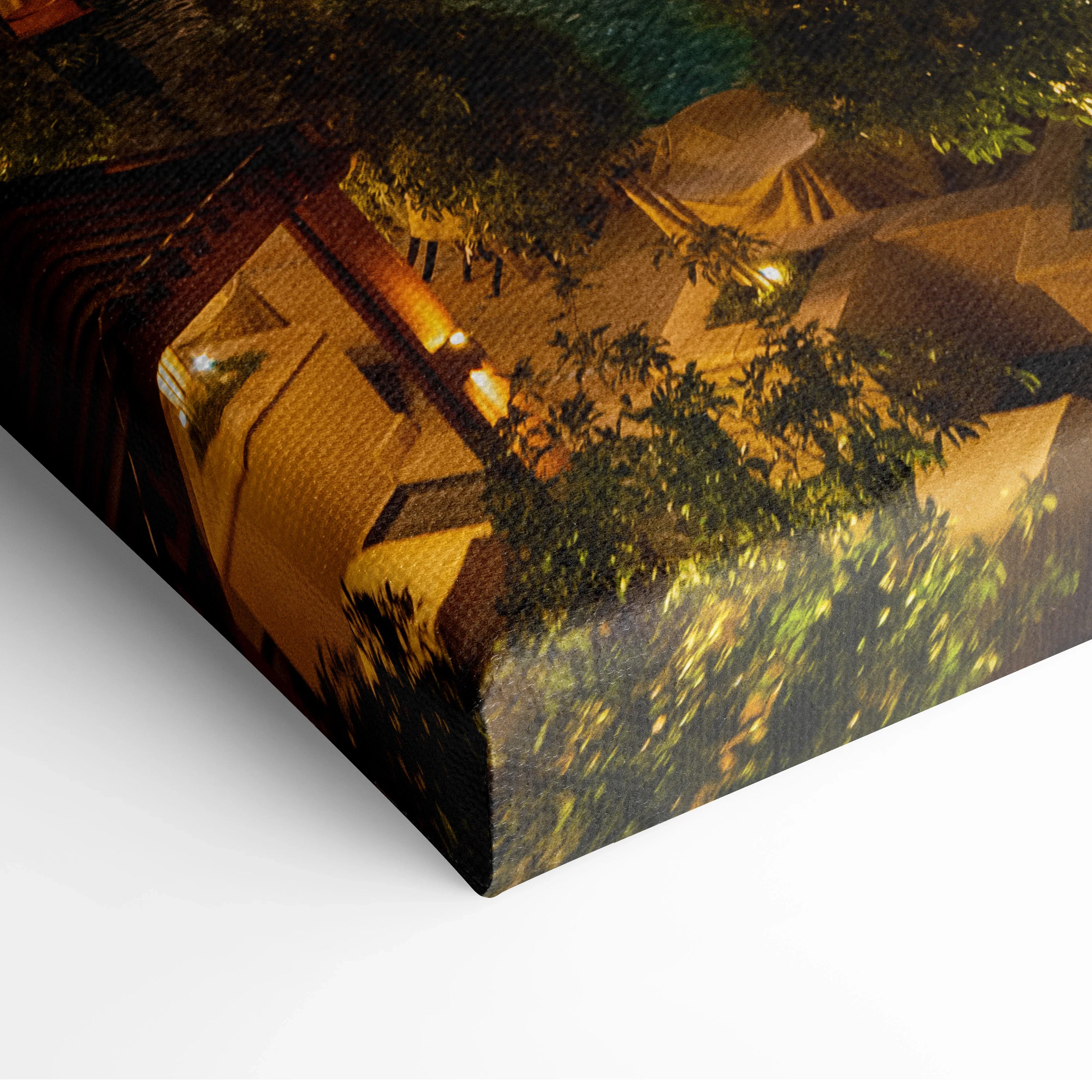 Canvas wall art print featuring a nighttime view of modern buildings with warm lighting and leafy trees.