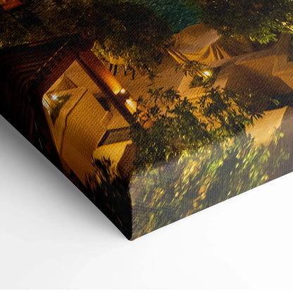 Canvas wall art print featuring a nighttime view of modern buildings with warm lighting and leafy trees.