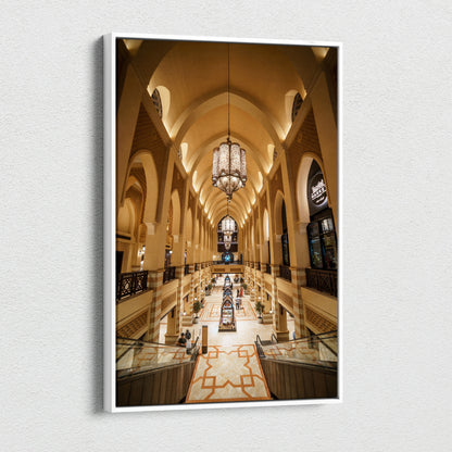 Vertical canvas art print of a grand architectural interior with beige arches, hanging chandeliers, and patterned floor.