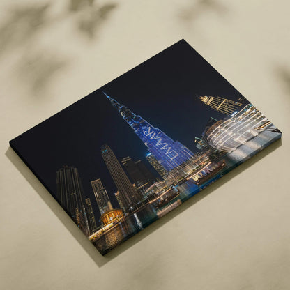 Elegant nighttime cityscape canvas wall art featuring illuminated modern skyscrapers and reflections on water.