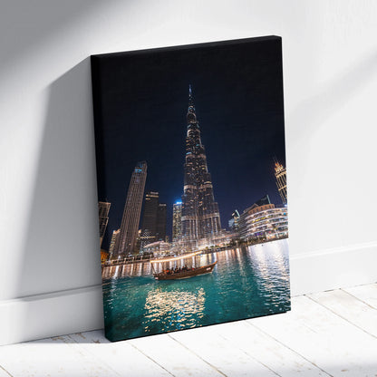 High-resolution canvas wall art of illuminated modern skyscrapers and a boat on water at night.