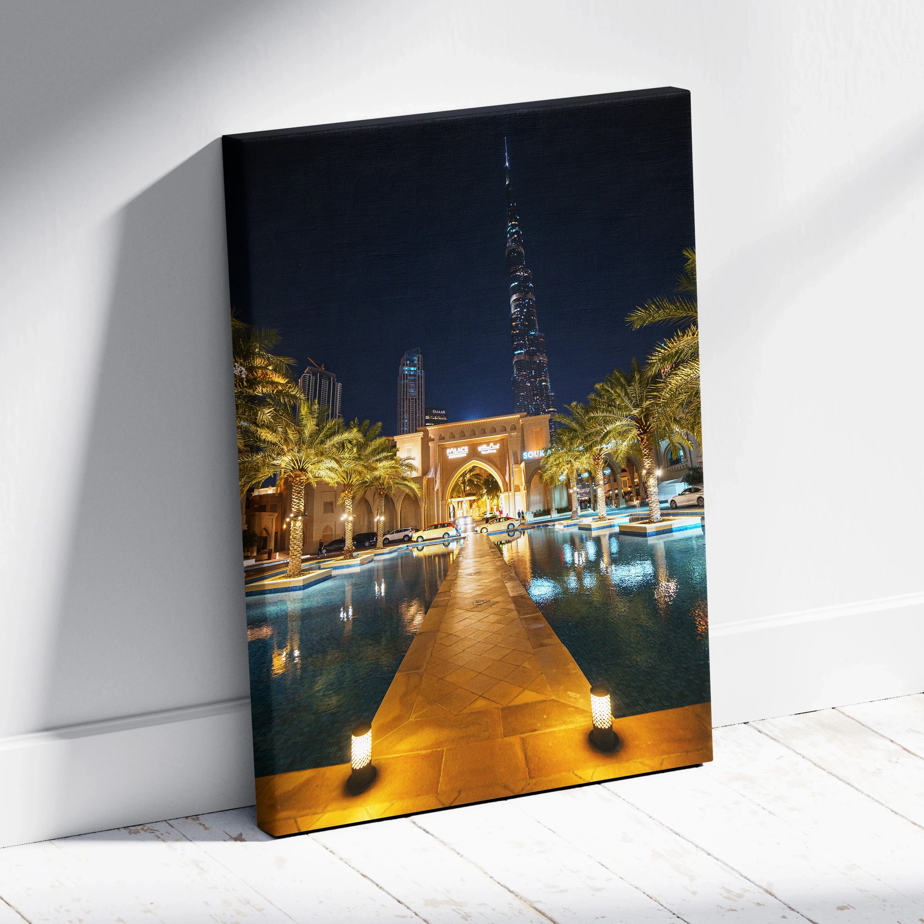 Vertical canvas art showcasing illuminated modern architecture and palm trees at night with reflective water and urban.