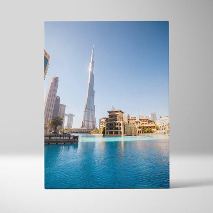 Canvas wall art featuring iconic skyscraper with surrounding buildings and blue water foreground.