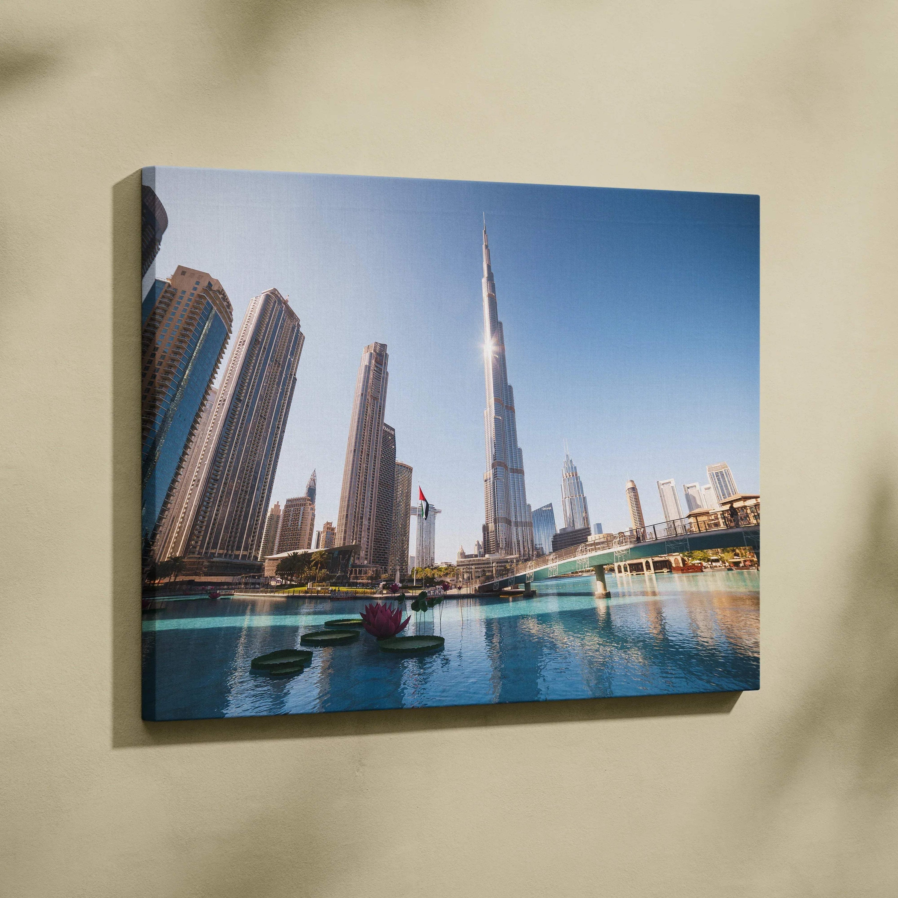 Canvas wall art print featuring a modern city skyline with tall glass skyscrapers and a blue sky reflection in calm water.