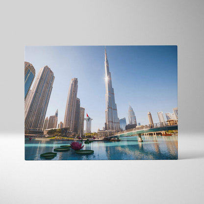 Canvas wall art featuring a bright cityscape with modern skyscrapers, including a tall, slender tower under a clear blue sky.